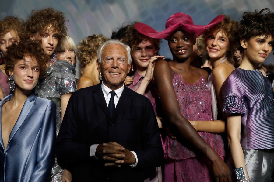 FILE - Designer Giorgio Armani, centre, poses with models at the end of his women's 2019 Spring-Summer collection, unveiled during the Fashion Week in Milan, Italy, Sunday, Sept. 23, 2018. (AP Photo/Luca Bruno, File)