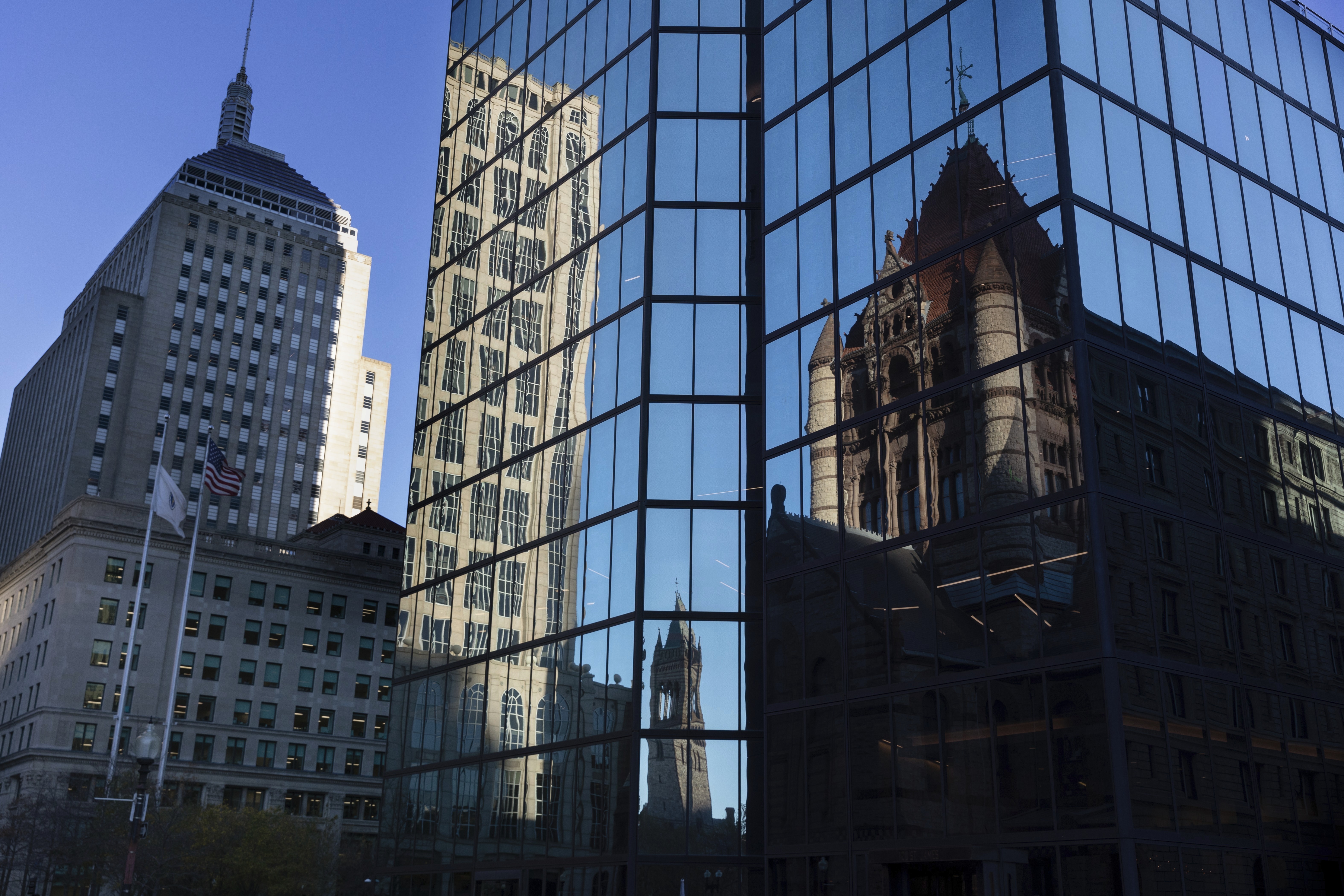 FILE - Buildings are reflected in 200 block of Clarendon Street, Nov. 8, 2022, in Boston. (AP Photo/Michael Dwyer, File)