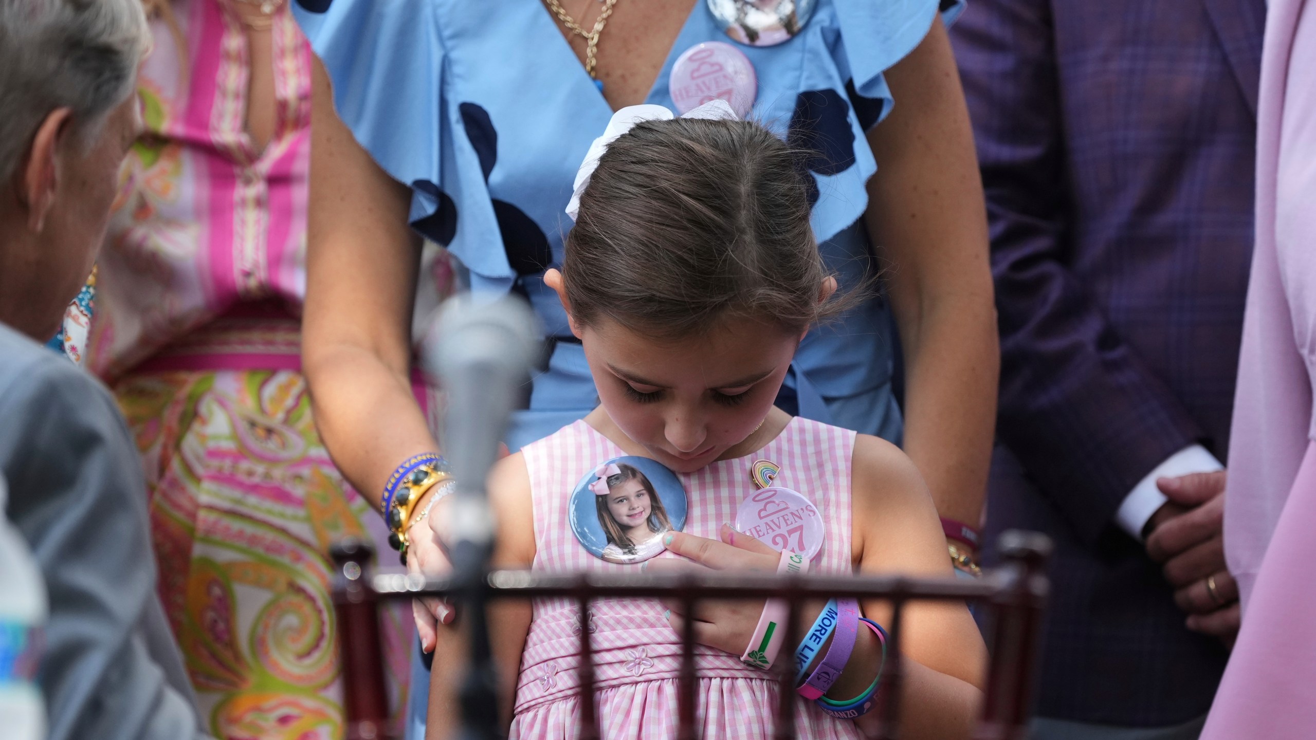 Texas Gov. Greg Abbott, left, visits with parents and family of children who died at Camp Mystic as he prepares to sign camp safety bills, Friday, Sept. 5, 2025, in Austin, Texas. (AP Photo/Eric Gay)