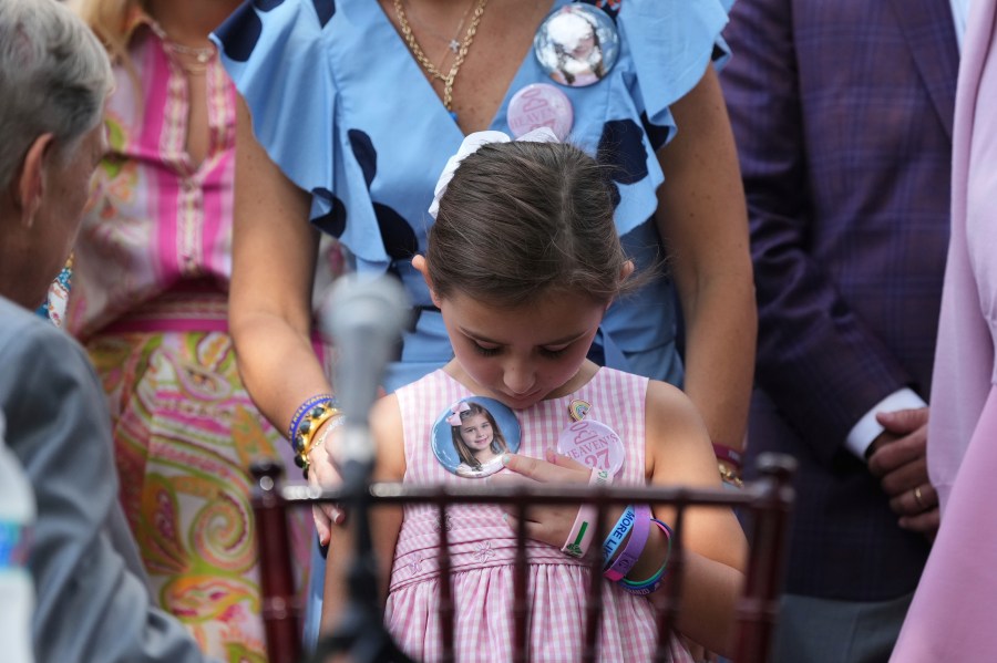 Texas Gov. Greg Abbott, left, visits with parents and family of children who died at Camp Mystic as he prepares to sign camp safety bills, Friday, Sept. 5, 2025, in Austin, Texas. (AP Photo/Eric Gay)