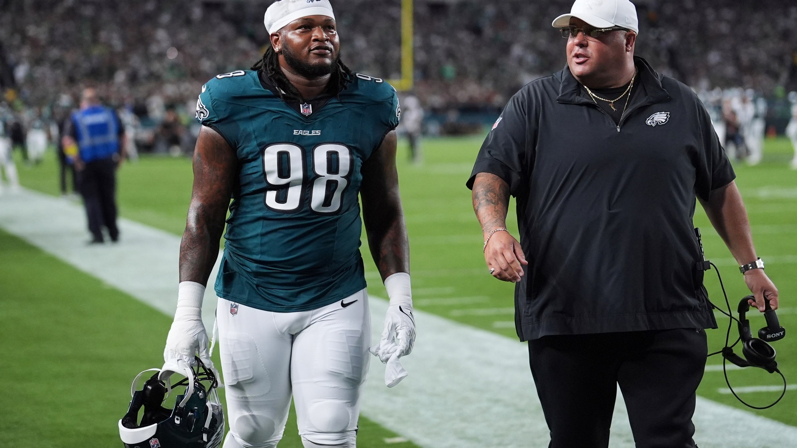 Philadelphia Eagles defensive tackle Jalen Carter (98) walks off the field after being disqualified for unsportsman like conduct before an NFL football game against the Dallas Cowboys Thursday, Sept. 4, 2025, in Philadelphia. (AP Photo/Matt Slocum)