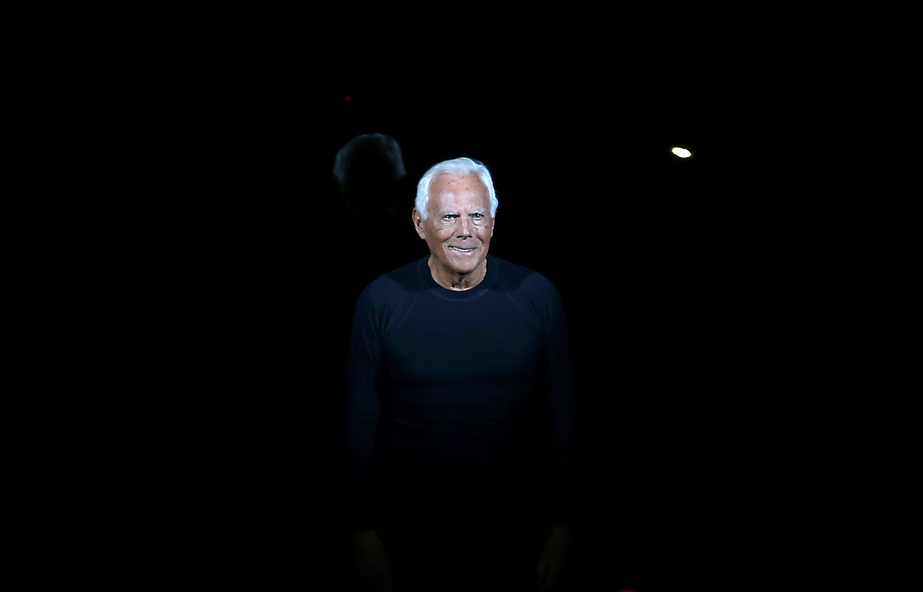 FILE - Italian fashion designer Giorgio Armani acknowledges applause at the end of his Emporio Armani men's Fall-Winter 2014 collection, part of the Milan Fashion Week, unveiled in Milan, Italy, Jan. 13, 2014. (AP Photo/Antonio Calanni, file)