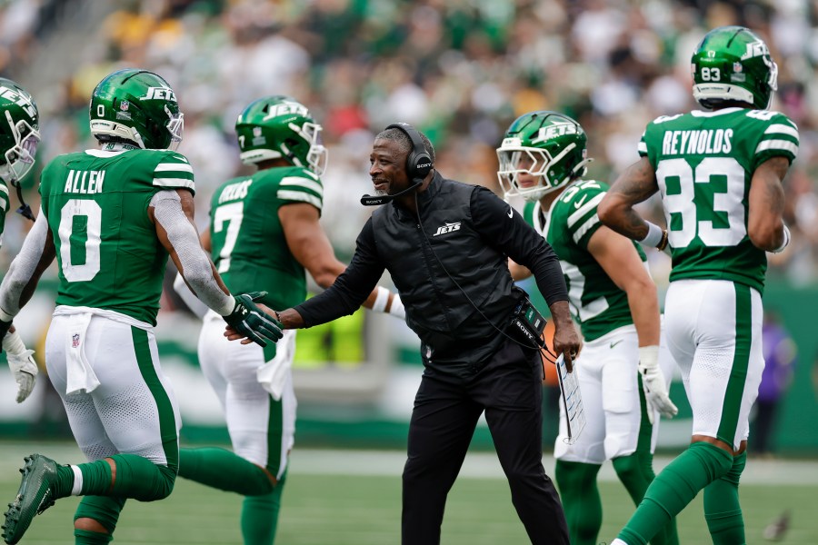 New York Jets head coach Aaron Glenn, center, reacts with running back Braelon Allen (0) after his team scored a touchdown against the Pittsburgh Steelers during the second half of an NFL football game Sunday, Sept. 7, 2025, in East Rutherford, N.J. (AP Photo/Adam Hunger)