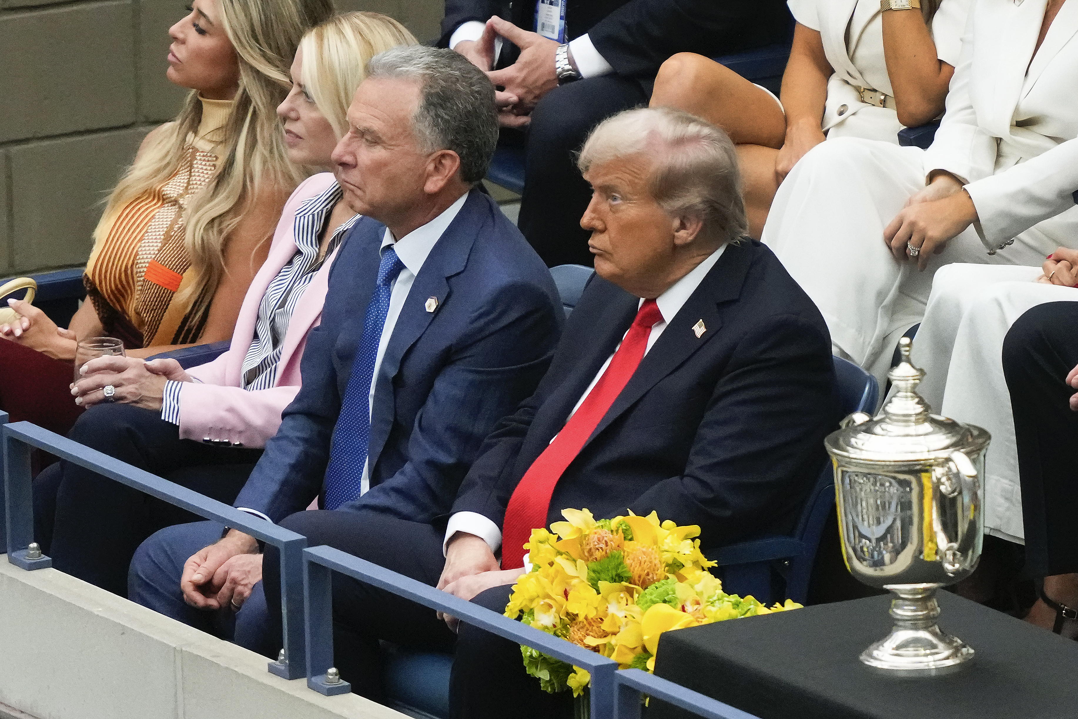 President Donald Trump, right, Steve Witkoff, center, and U.S. Attorney General, Pam Bondi, watch play between Carlos Alcaraz, of Spain, and Jannik Sinner, of Italy, during the men's singles final of the U.S. Open tennis championships, Sunday, Sept. 7, 2025, in New York. (AP Photo/Yuki Iwamura)