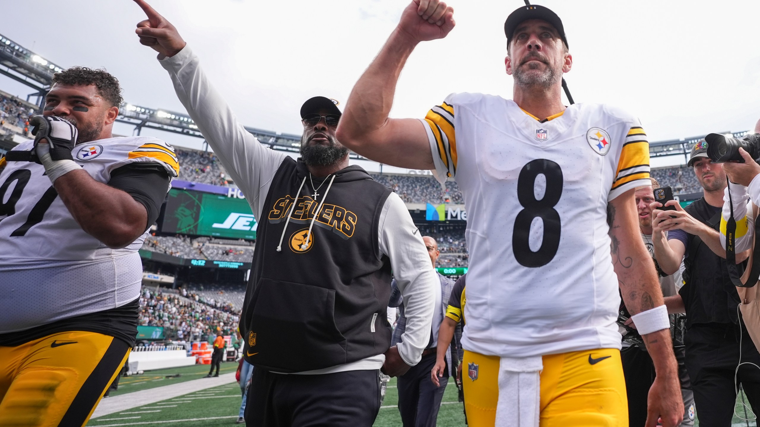 Pittsburgh Steelers defensive tackle Cam Heyward (97), head coach Mike Tomlin, center, and quarterback Aaron Rodgers (8) leave the field following an NFL football game against the New York Jets Sunday, Sept. 7, 2025, in East Rutherford, N.J. (AP Photo/Matt Slocum)