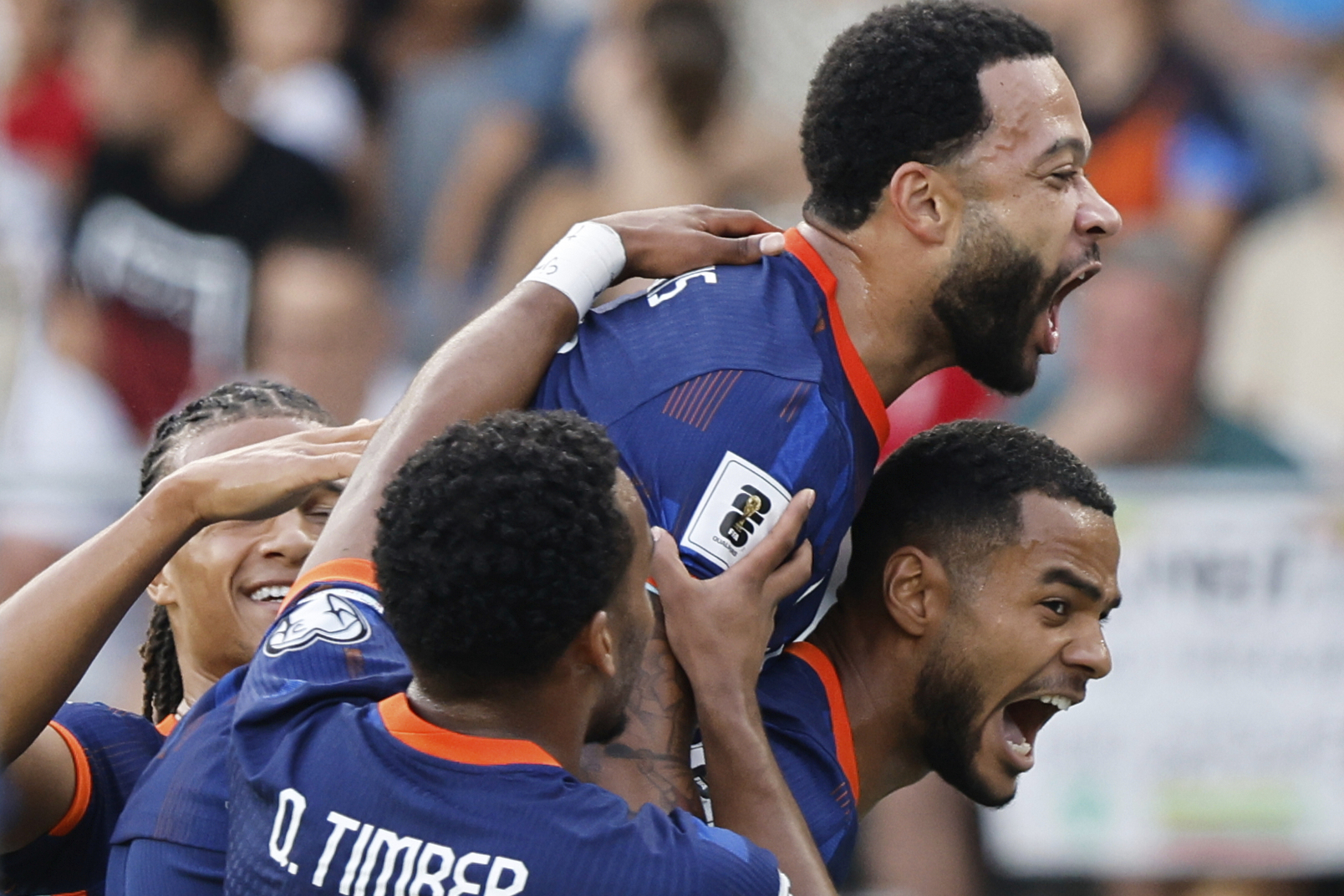 Dutch players celebrate their side's first goal scored by Memphis Depay, top, during the World Cup qualifying soccer match between Lithuania and Netherlands at Darius and Girenas stadium in Kaunas, Lithuania, Sunday, Sept. 7, 2025. (AP Photo/Mindaugas Kulbis)