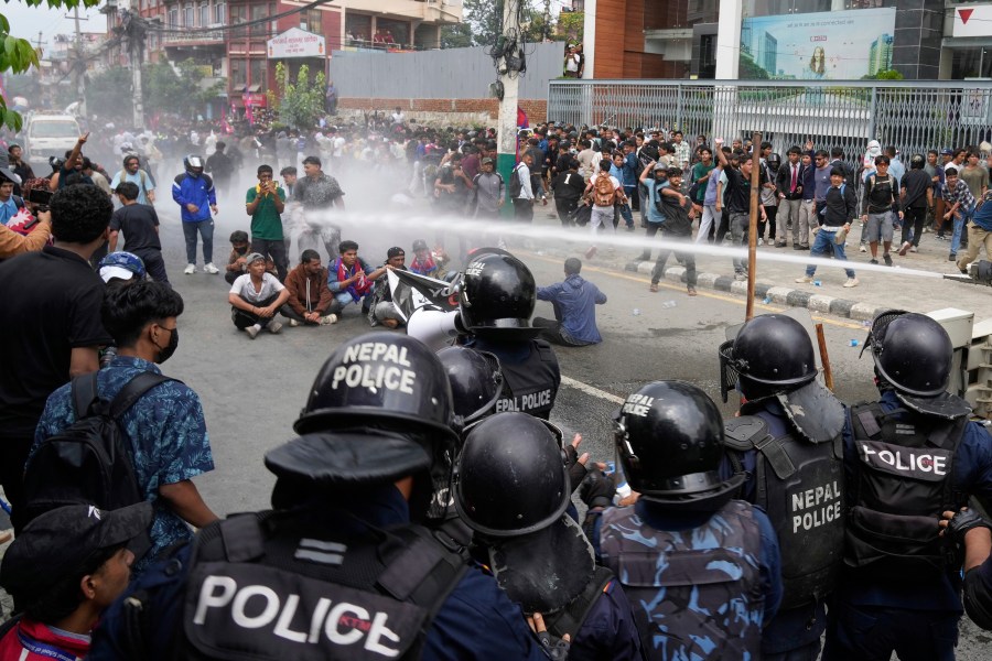 Riot police use water cannon on protesters during clashes outside parliament building in Kathmandu, Nepal, Monday, Sept. 8, 2025. (AP Photo/Niranjan Shrestha)