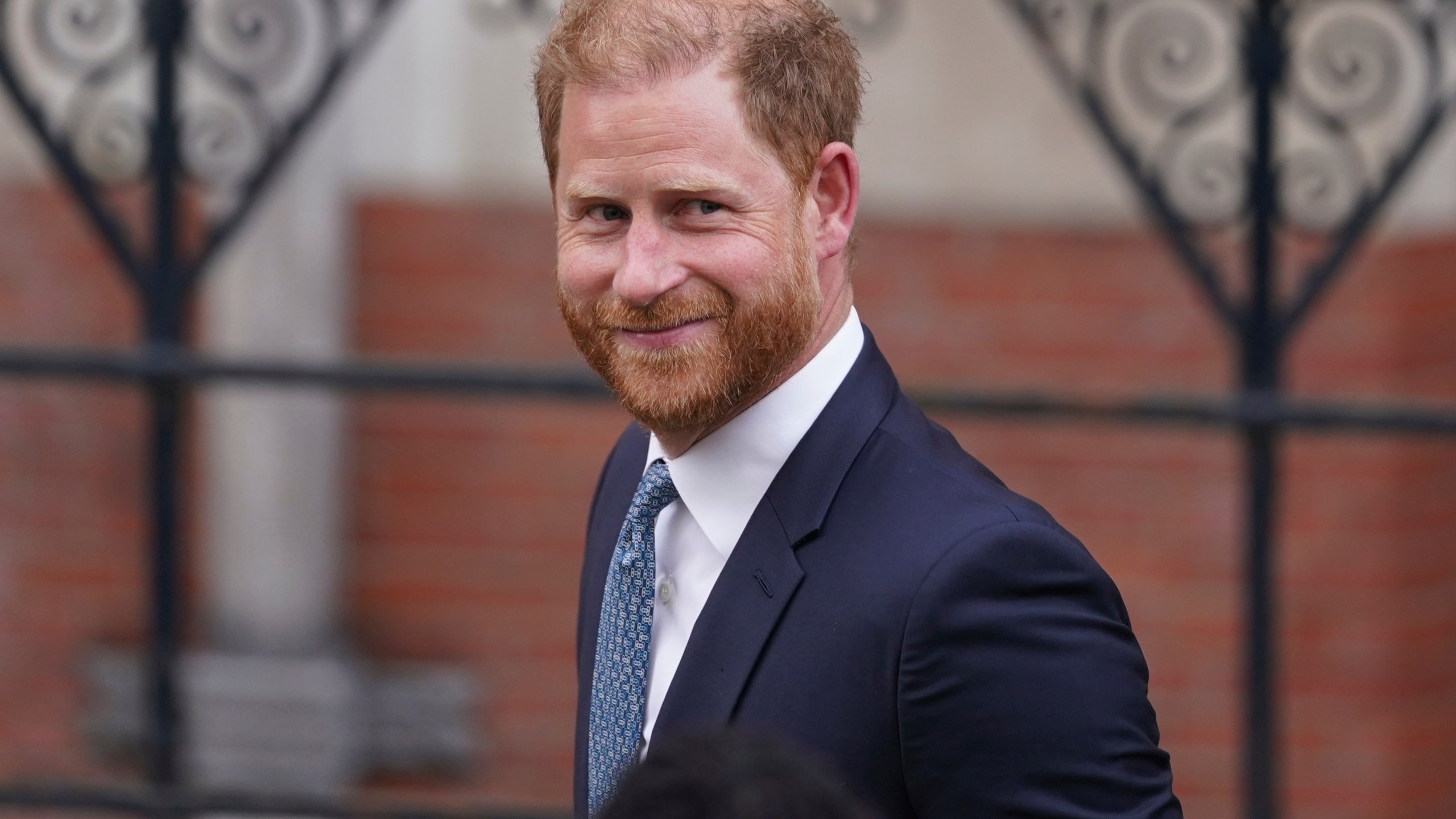 FILE - Britain's Prince Harry smiles towards the media as he leaves the Royal Courts of Justice in London, Tuesday, April 8, 2025. (AP Photo/Alberto Pezzali, File)