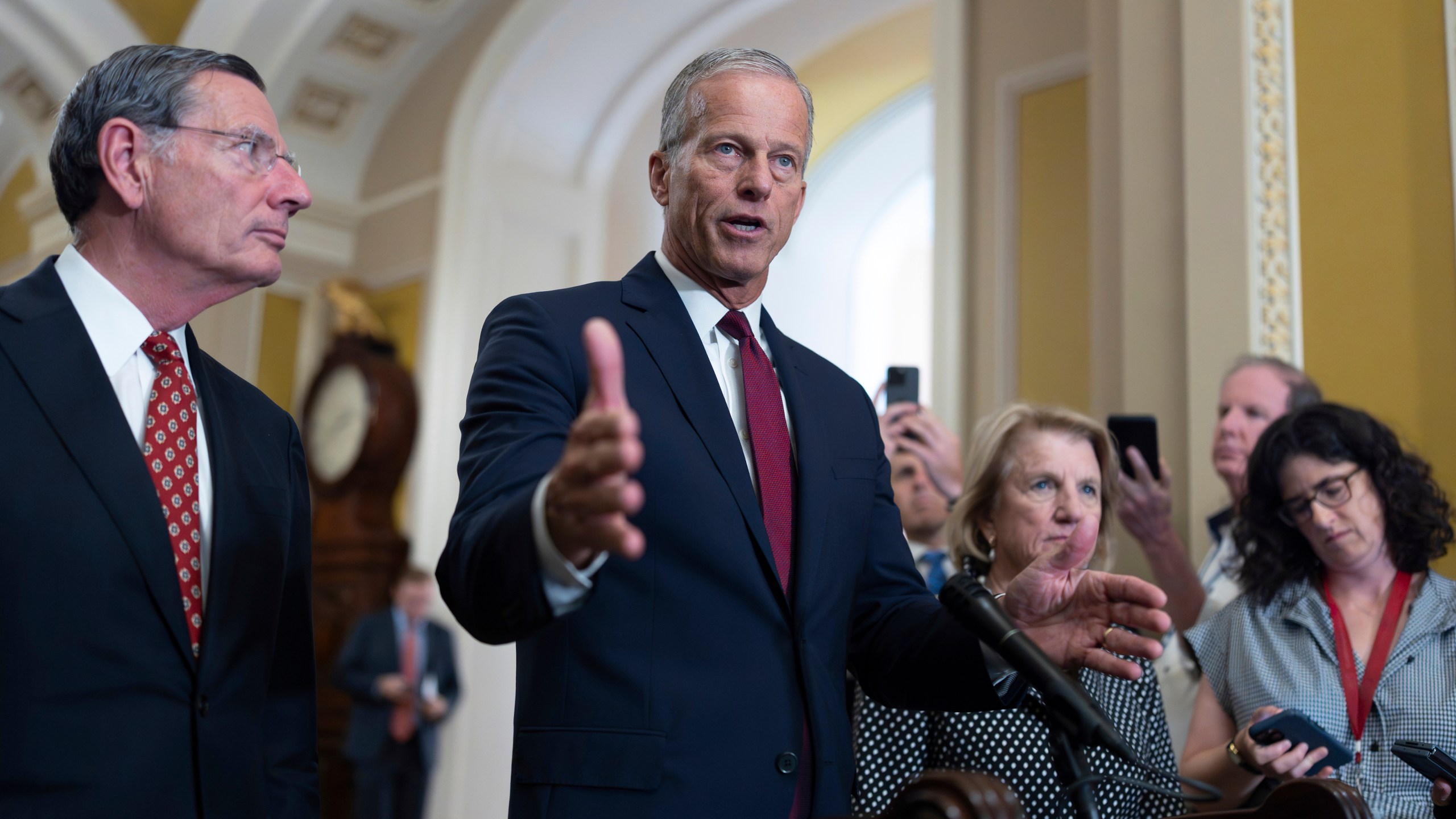 FILE - Senate Majority Leader John Thune, R-S.D., joined at left by Sen. John Barrasso, R-Wyo., the GOP whip, speaks to reporters following closed-door strategy meetings, at the Capitol in Washington, July 22, 2025. (AP Photo/J. Scott Applewhite, File)