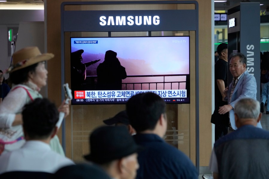 A TV screen shows an image of North Korean leader Kim Jong Un, second from right, supervising a test of a new rocket engine during a news program at the Seoul Railway Station in Seoul, South Korea, Tuesday, Sept. 9, 2025. (AP Photo/Ahn Young-joon)
