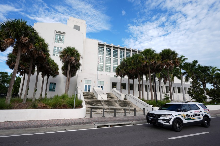 A police car drives past the Alto Lee Adams Sr. U.S. Courthouse as jury selection began in the trial of Ryan Routh, charged with trying to assassinate Donald Trump while he played golf last year in South Florida, Monday, Sept. 8, 2025, in Fort Pierce, Fla. (AP Photo/Rebecca Blackwell)