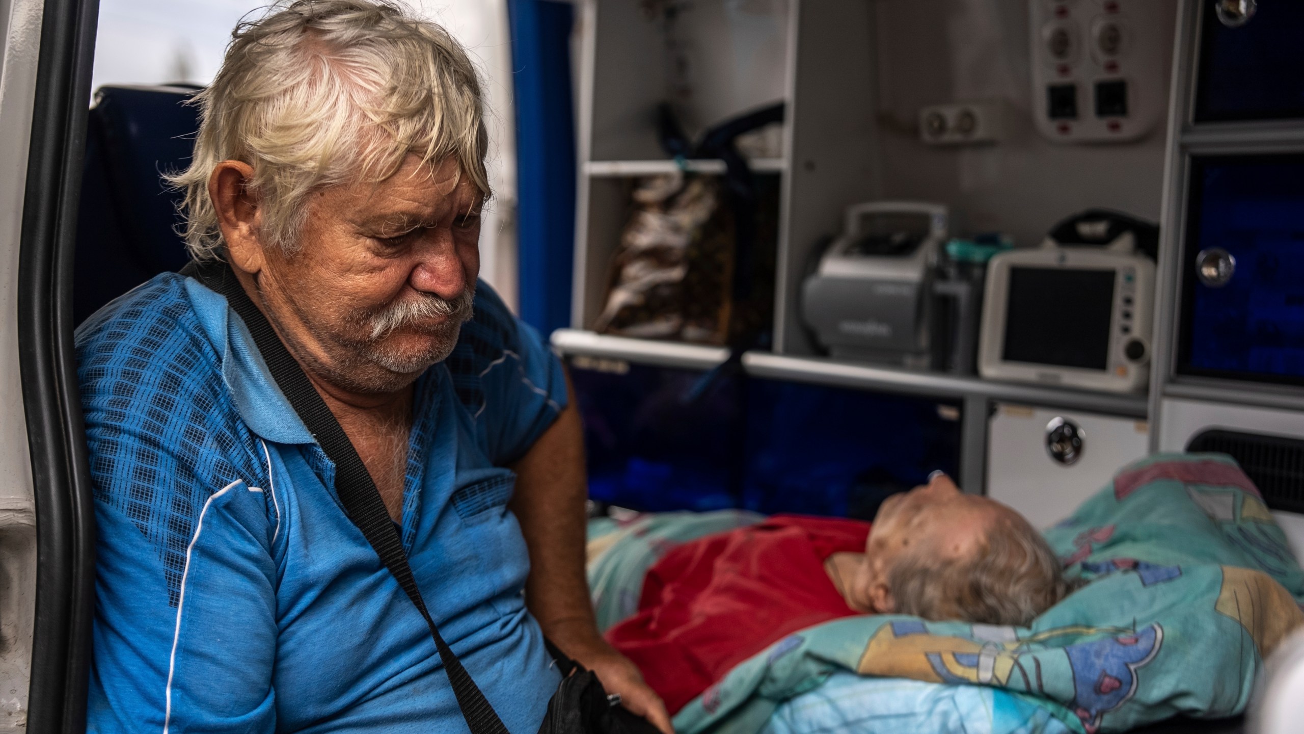 Myrola Puzyk, 70, who lost his wife Tetiana Puzyk, 68, who was killed while she was receiving her pension in the village of Yarova during a Russian aerial strike, seats in the ambulance during evacuation in Sloviansk, Donetsk region, Tuesday, Sept.9, 2025. (AP Photo/Alex Babenko)