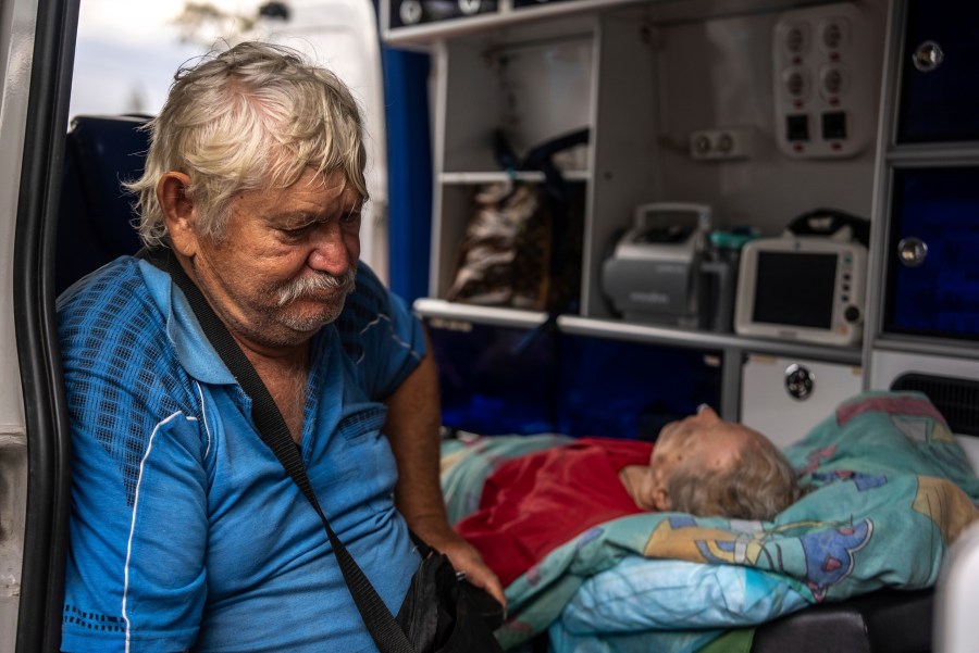 Myrola Puzyk, 70, who lost his wife Tetiana Puzyk, 68, who was killed while she was receiving her pension in the village of Yarova during a Russian aerial strike, seats in the ambulance during evacuation in Sloviansk, Donetsk region, Tuesday, Sept.9, 2025. (AP Photo/Alex Babenko)