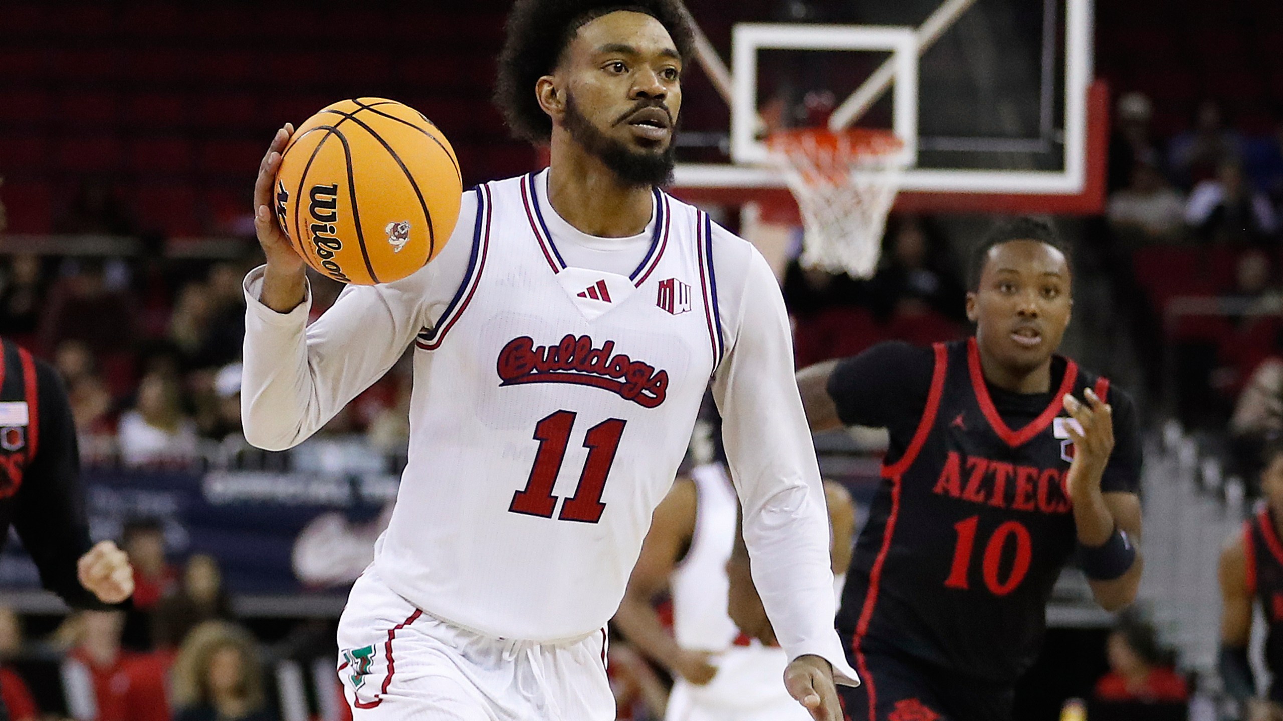 FILE - Fresno State's Mykell Robinson drives against San Diego State during the second half of an NCAA college basketball game in Fresno, Calif., Wednesday, Dec. 4, 2024. (AP Photo/Gary Kazanjian, File)