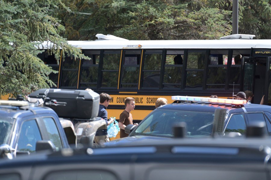 Students board a bus amid heavy police presence at the Evergreen Library after a shooting at Evergreen High School Wednesday, Sept. 10, 2025, in Evergreen, Colo. (Hyoung Chang/The Denver Post via AP)