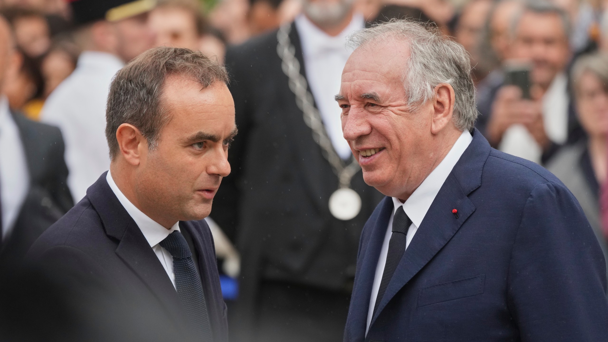 Newly named Prime Minister Sebastien Lecornu, left, is welcomed by outgoing French Prime Minister Francois Bayrou, right, for a handover ceremony at the Prime Minister residence, in Paris, France, Wednesday, Sept. 10, 2025. (AP Photo/Christophe Ena)