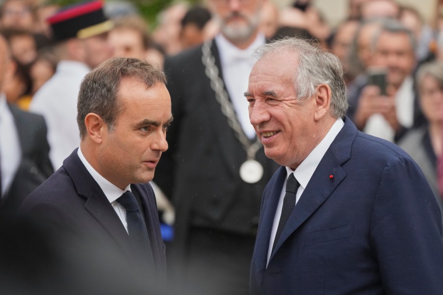 Newly named Prime Minister Sebastien Lecornu, left, is welcomed by outgoing French Prime Minister Francois Bayrou, right, for a handover ceremony at the Prime Minister residence, in Paris, France, Wednesday, Sept. 10, 2025. (AP Photo/Christophe Ena)