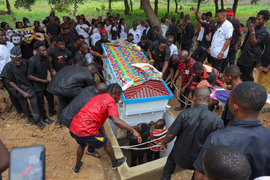 The fantasy coffin of the late Robert Nii Anang Obodai, a former school proprietor, is lowered into his grave in Accra, Ghana, Saturday, July 26, 2025. (AP Photo/Misper Apawu)