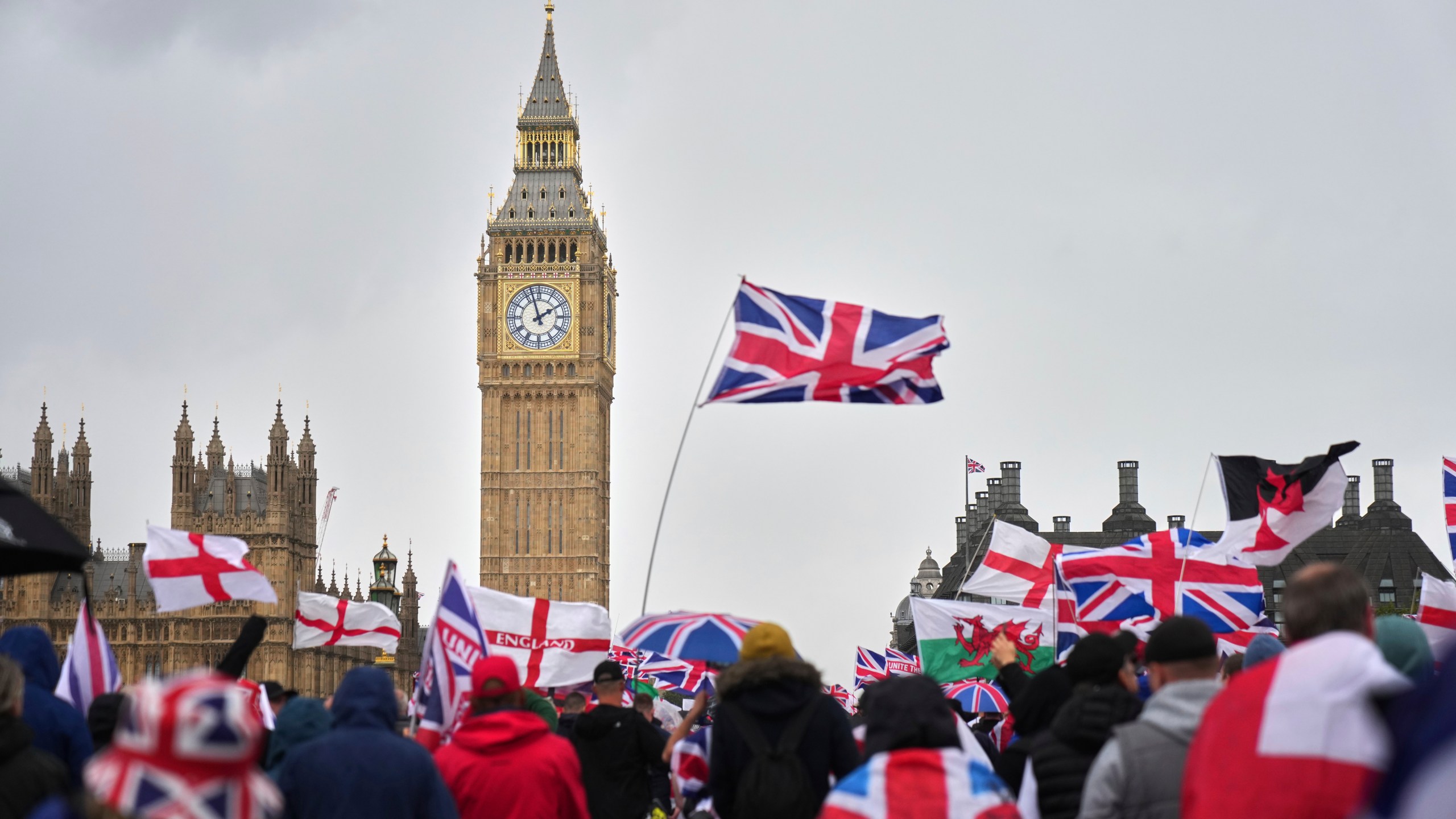 Demonstrators take part in the Tommy Robinson-led Unite the Kingdom march and rally near Westminster, London, Saturday Sept. 13, 2025. (AP Photo/Joanna Chan)