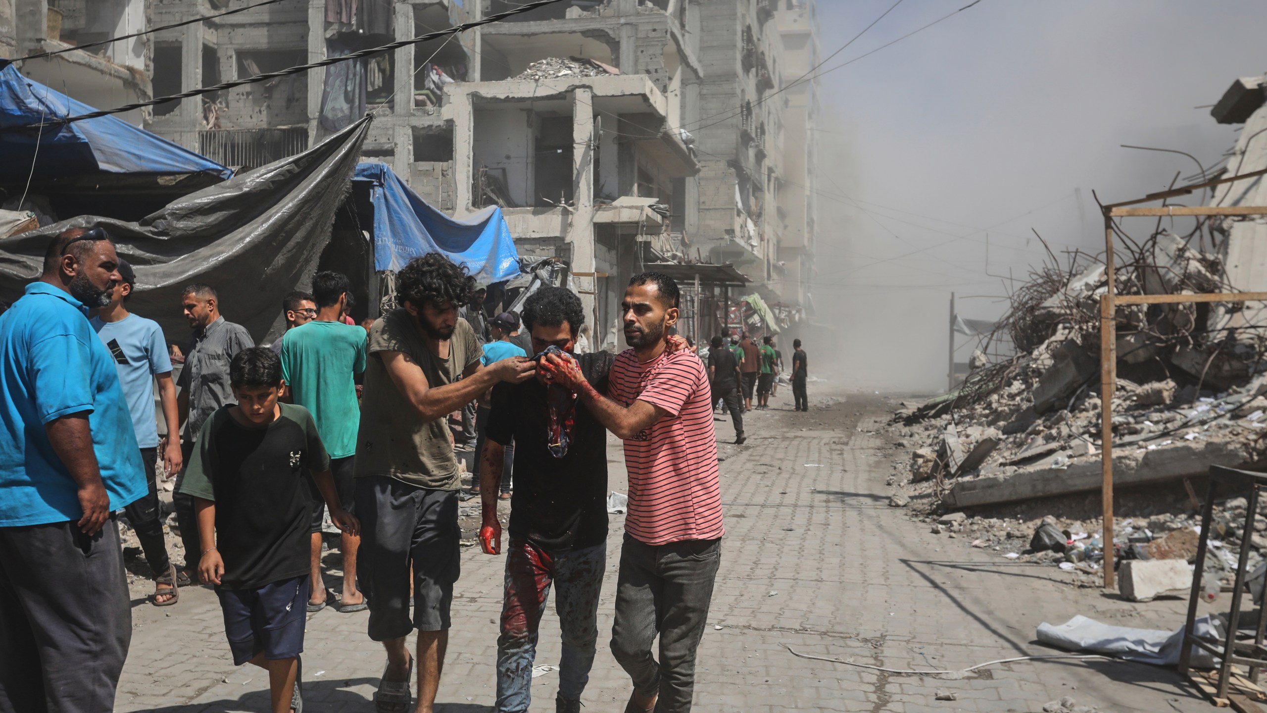 Palestinians evacuate a man who was injured in an Israeli military strike on a building in Gaza City, Saturday, Sept. 13, 2025. (AP Photo/Yousef Al Zanoun)