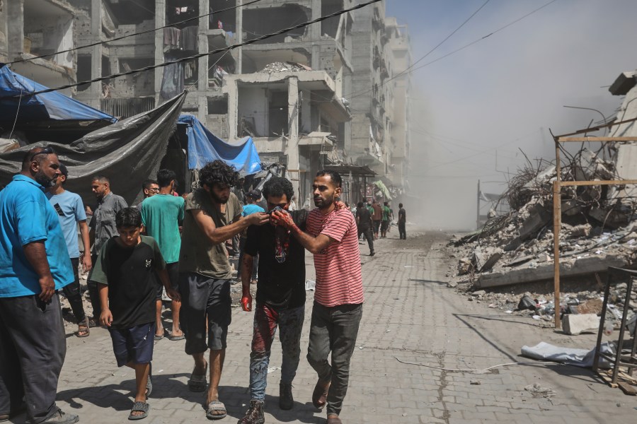Palestinians evacuate a man who was injured in an Israeli military strike on a building in Gaza City, Saturday, Sept. 13, 2025. (AP Photo/Yousef Al Zanoun)