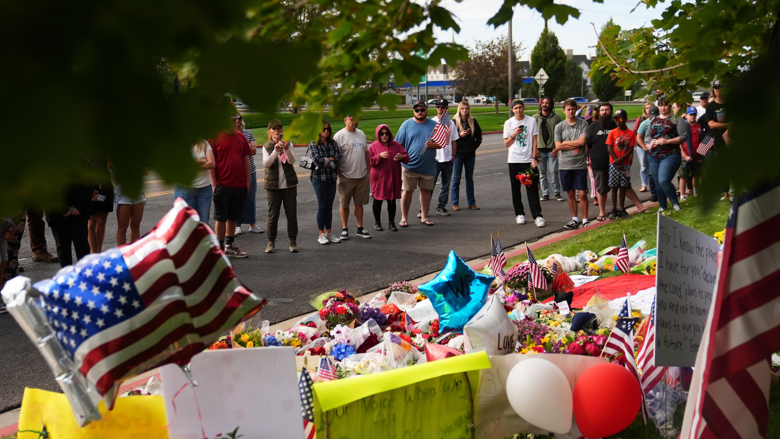 Supporters gather at a makeshift memorial in Orem, Utah, Saturday, Sept. 13, 2025, at Utah Valley University for Turning Point USA CEO and co-founder Charlie Kirk who was fatally shot during an event on the campus. (AP Photo/Lindsey Wasson)