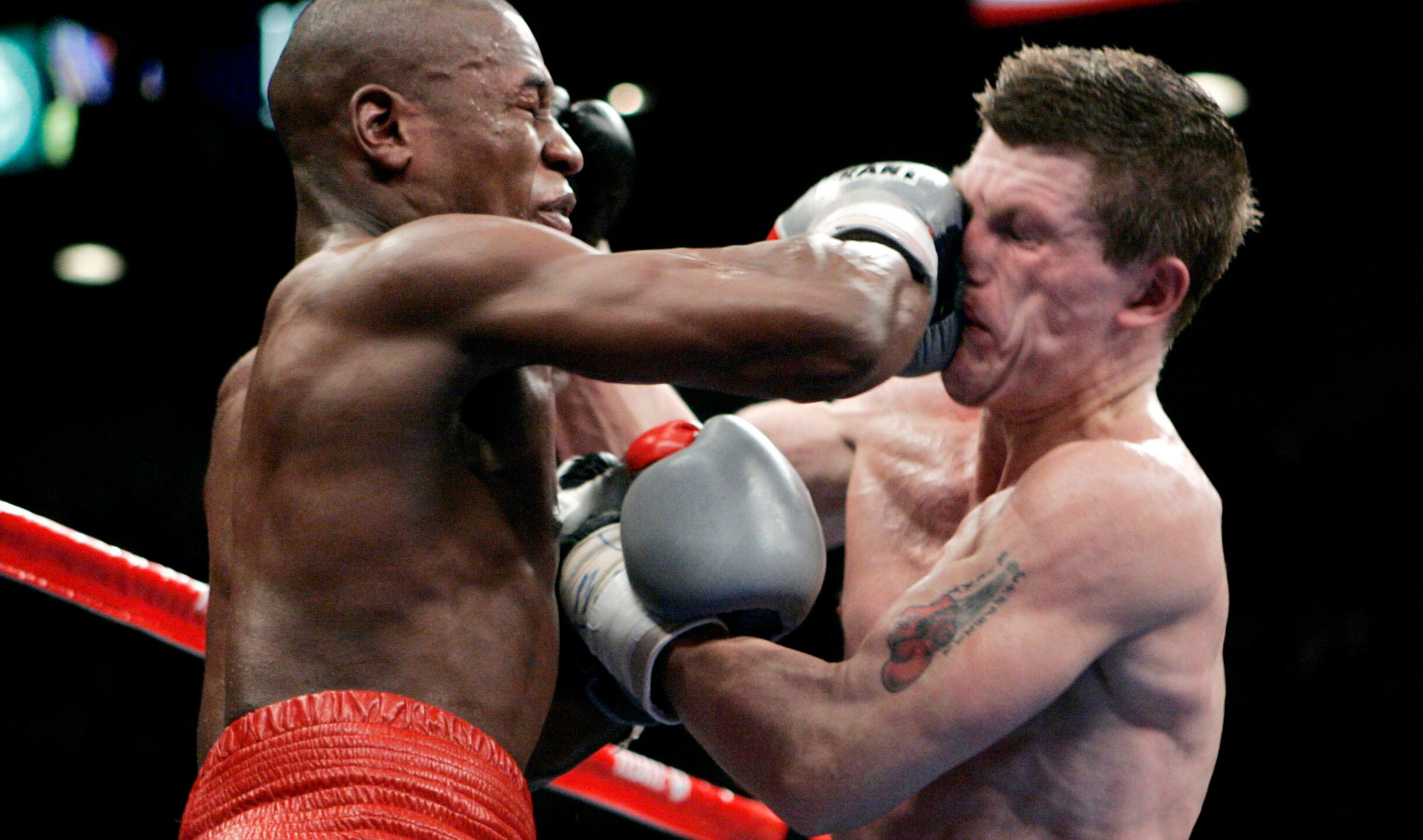 FILE - Floyd Mayweather Jr., left, punches Ricky Hatton, of Great Britain, during their WBC welterweight boxing title fight at the MGM Grand hotel-casino in Las Vegas, Saturday, Dec. 8, 2007. Mayweather won by 10th round knockout. (AP Photo/Jae C. Hong, File)