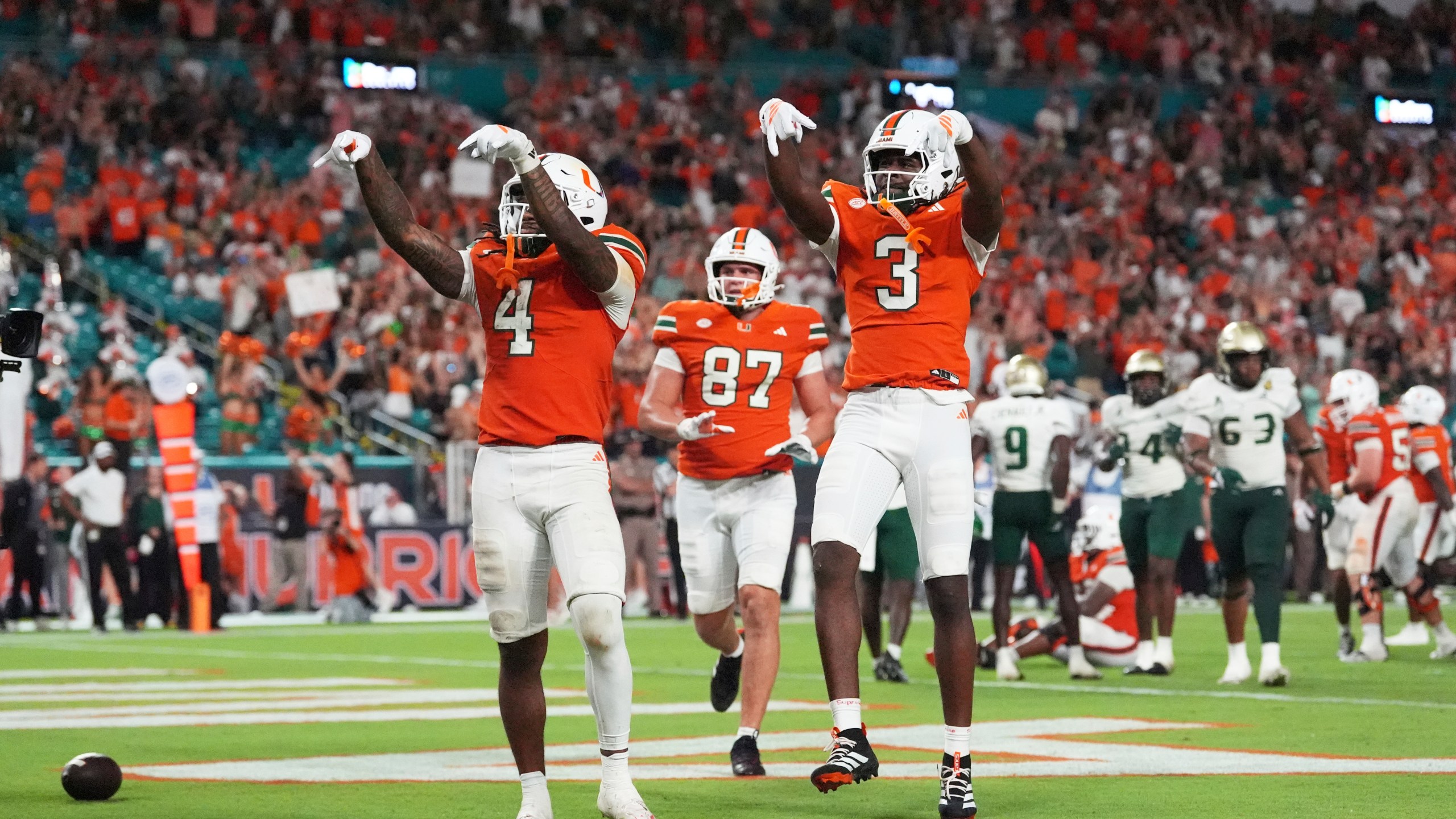 Miami Hurricanes running back Mark Fletcher Jr. (4) celebrates with Miami Hurricanes wide receiver Joshua Moore (3) after scoring a touchdown during the second half of an NCAA college football game against South Florida, Saturday, Sept. 13, 2025, in Miami Gardens, Fla. (AP Photo/Rebecca Blackwell)