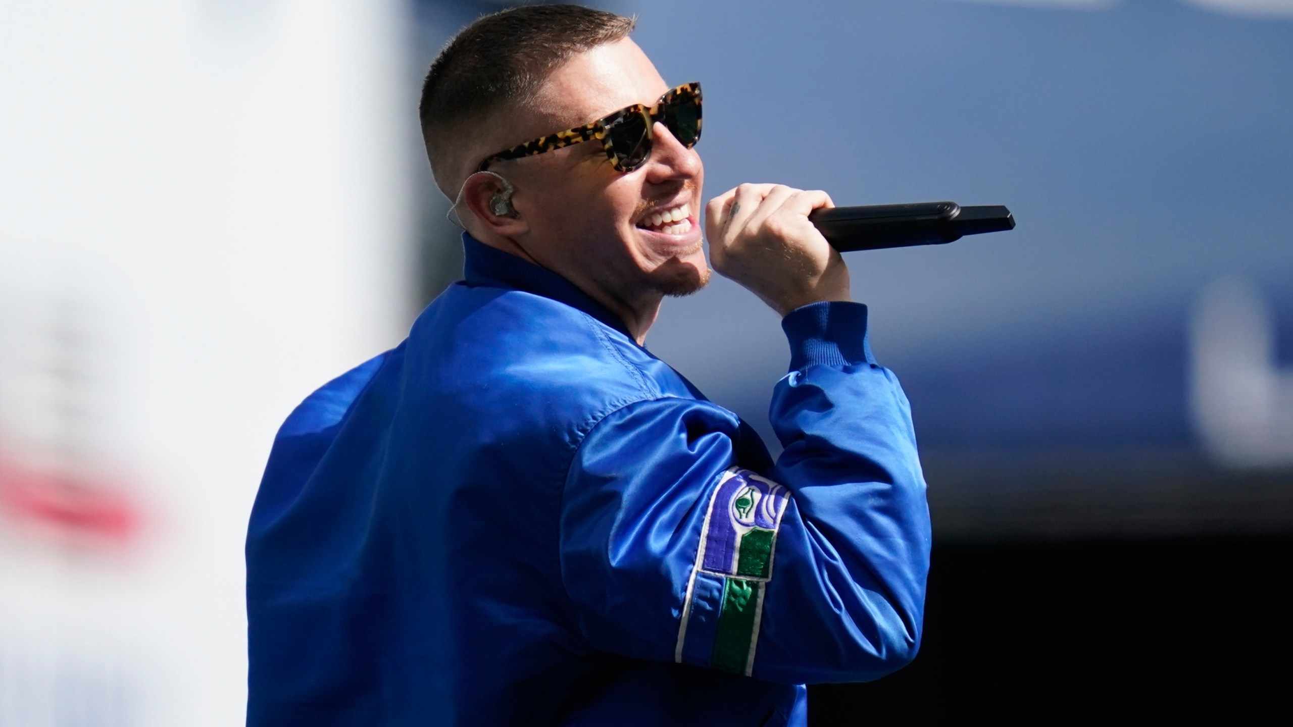 FILE - Rap singer Macklemore performs before an NFL football game between the Seattle Seahawks and the Tennessee Titans, Sept. 19, 2021, in Seattle. (AP Photo/Elaine Thompson, File)
