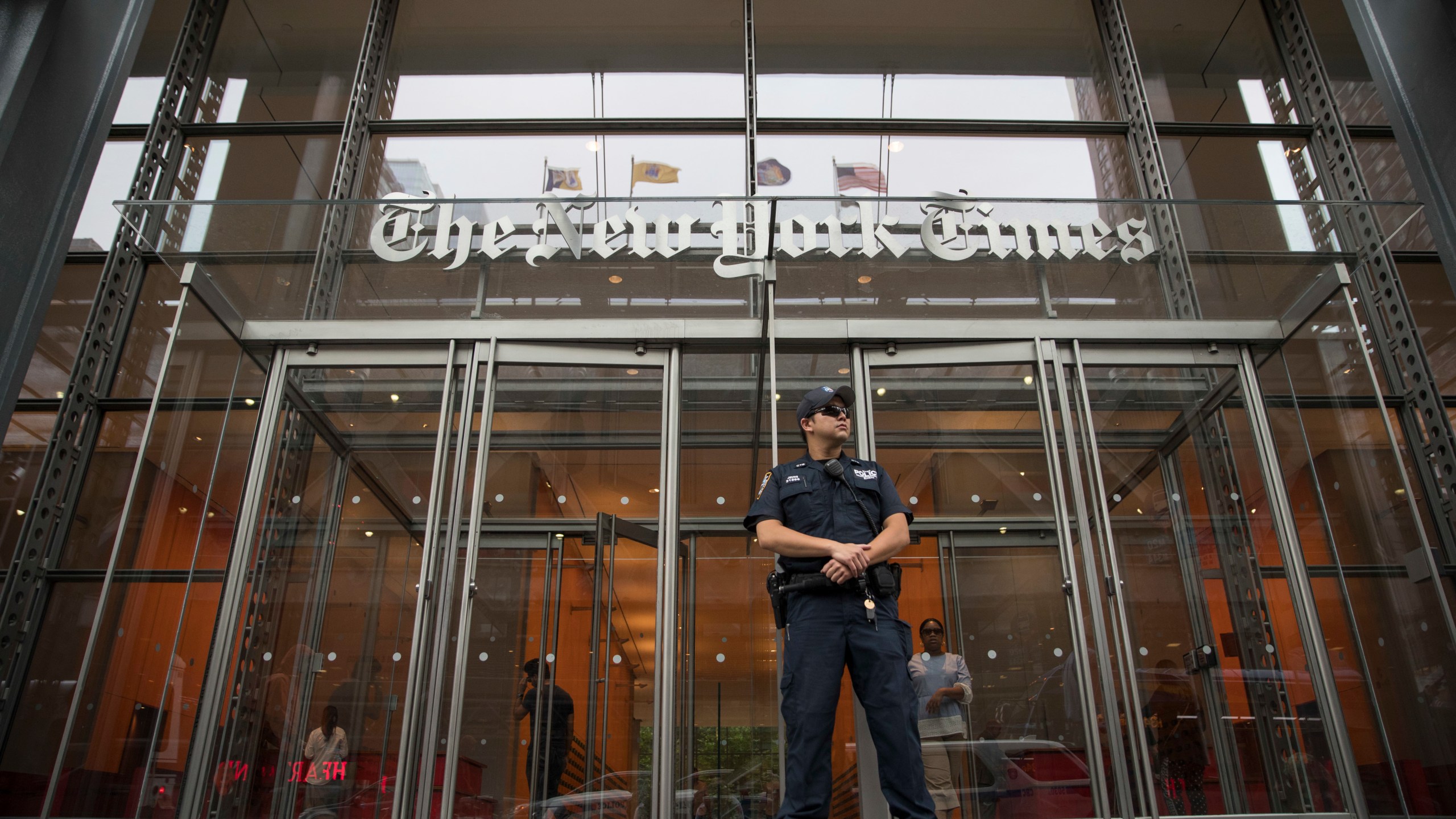 FILE- A police officer stands guard outside The New York Times building in New York, on June 28, 2018. (AP Photo/Mary Altaffer, File)