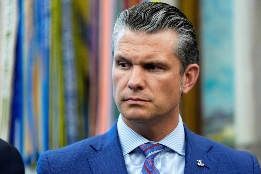 Defense Secretary Pete Hegseth listens as President Donald Trump speaks in the Oval Office of the White House, Monday, Sept. 15, 2025, in Washington. (AP Photo/Alex Brandon)