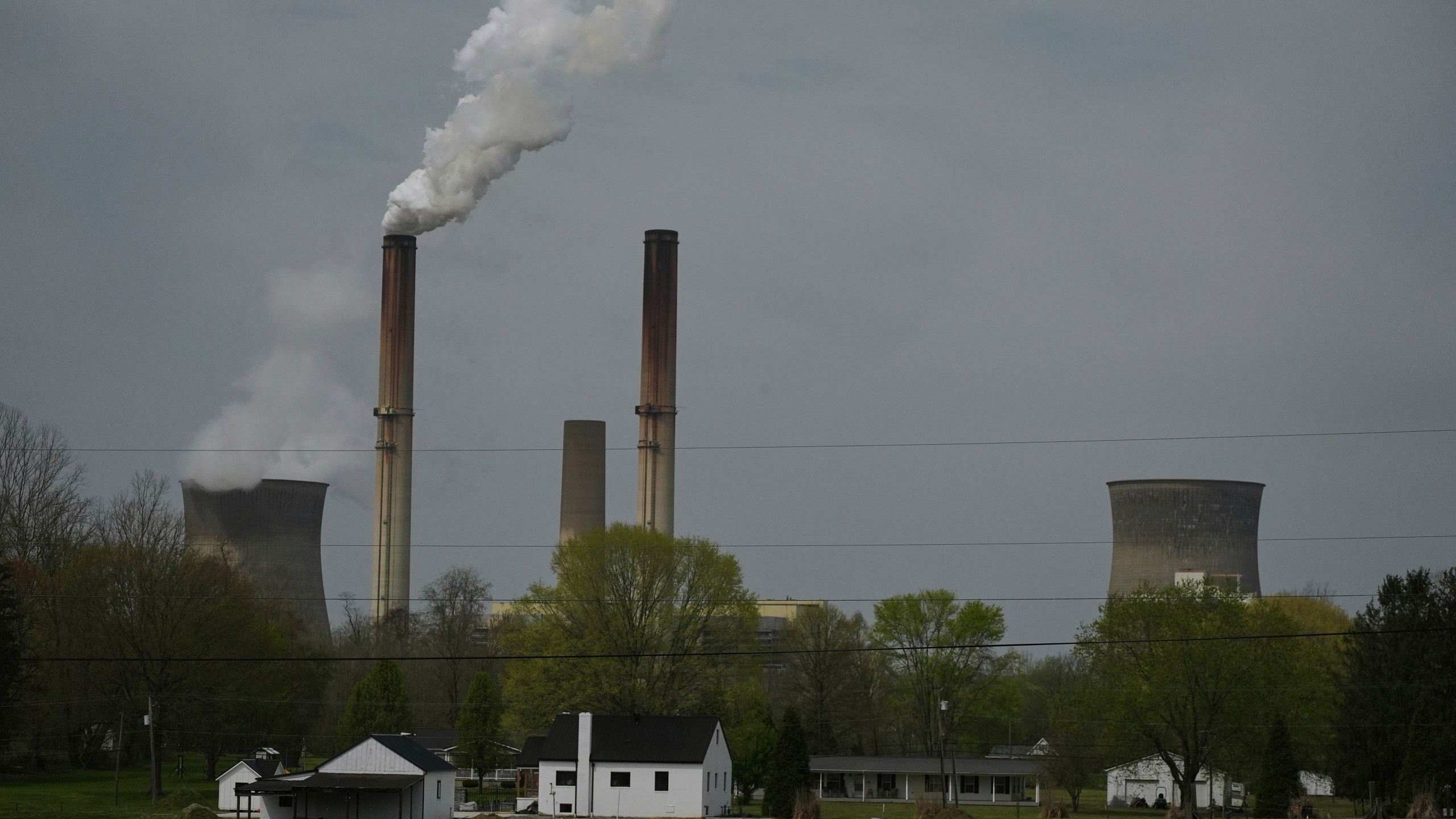 FILE - A home sits near the Gen. James Gavin Power Plant, a coal-fired power plant, April 14, 2025, in Point Pleasant, W.Va. (AP Photo/Joshua A. Bickel, File)