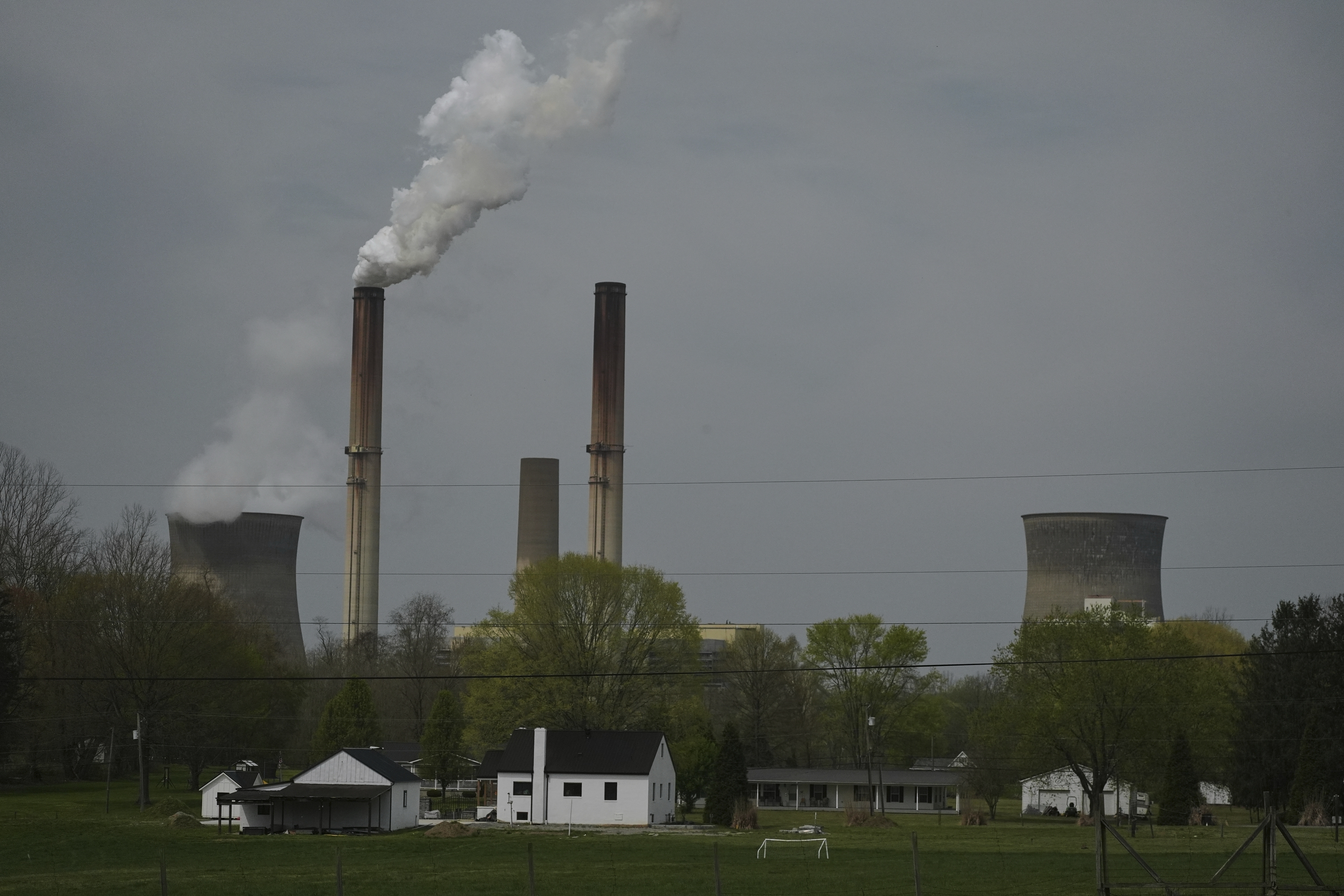 FILE - A home sits near the Gen. James Gavin Power Plant, a coal-fired power plant, April 14, 2025, in Point Pleasant, W.Va. (AP Photo/Joshua A. Bickel, File)