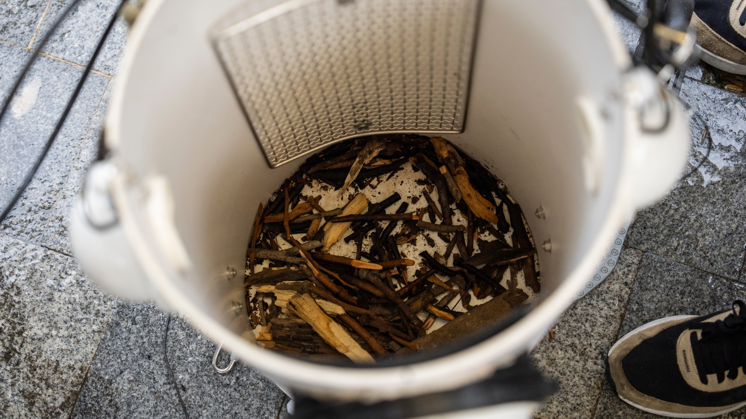 Sticks are placed on the bottom of an artificial nest box for wild yellow-crested cockatoos in Victoria Park in Hong Kong, on Aug. 18, 2025. (AP Photo/Chan Long Hei)