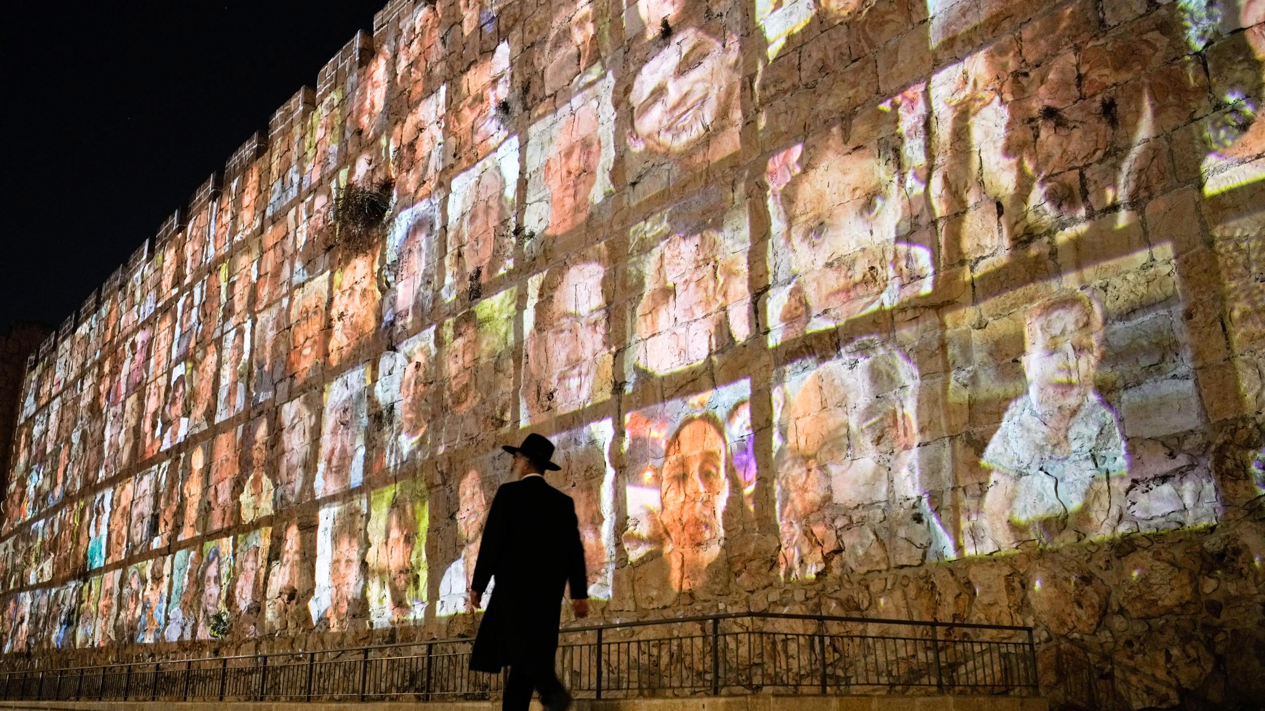 FILE - Photographs of Israeli hostages being held by Hamas militants are projected on the walls of Jerusalem's Old City, Nov. 6, 2023. The Islamic militant group killed around 1,200 people, mostly civilians, and abducted 251 others on Oct. 7, 2023. (AP Photo/Leo Correa, File)
