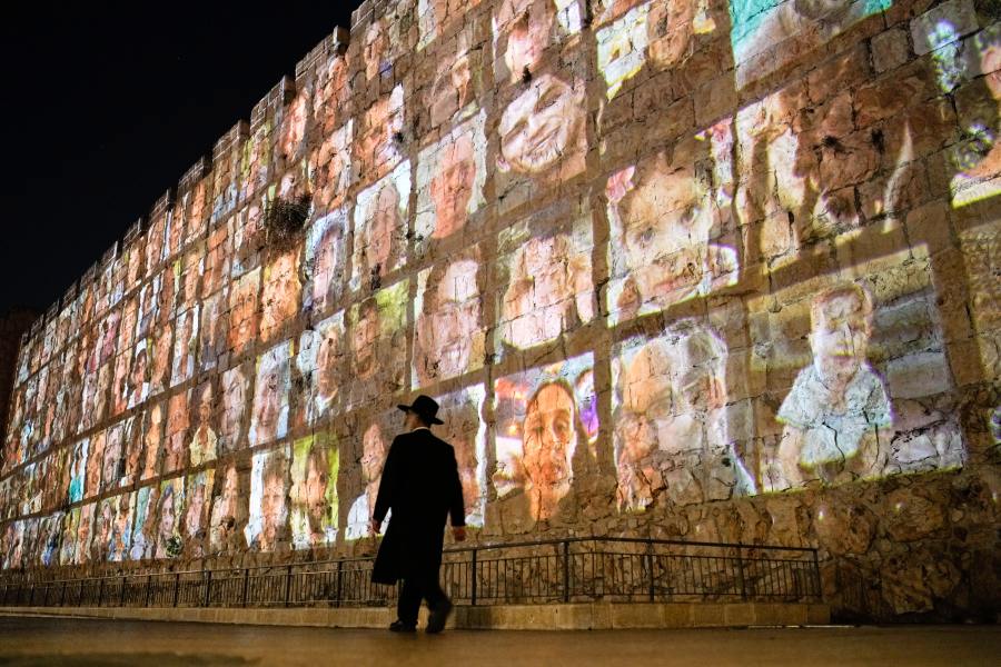 FILE - Photographs of Israeli hostages being held by Hamas militants are projected on the walls of Jerusalem's Old City, Nov. 6, 2023. The Islamic militant group killed around 1,200 people, mostly civilians, and abducted 251 others on Oct. 7, 2023. (AP Photo/Leo Correa, File)