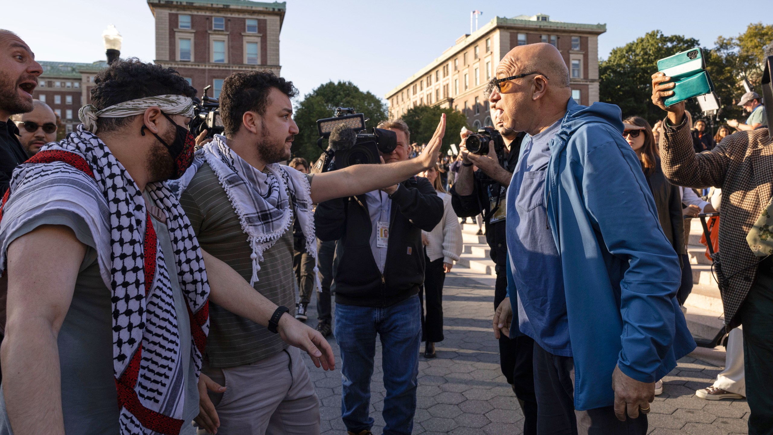 FILE - Pro-Palestinian demonstrator Mahmoud Khalil, second from left, debates with a pro-Israel demonstrator during a protest at Columbia University, Oct. 12, 2023, in New York. (AP Photo/Yuki Iwamura, file)