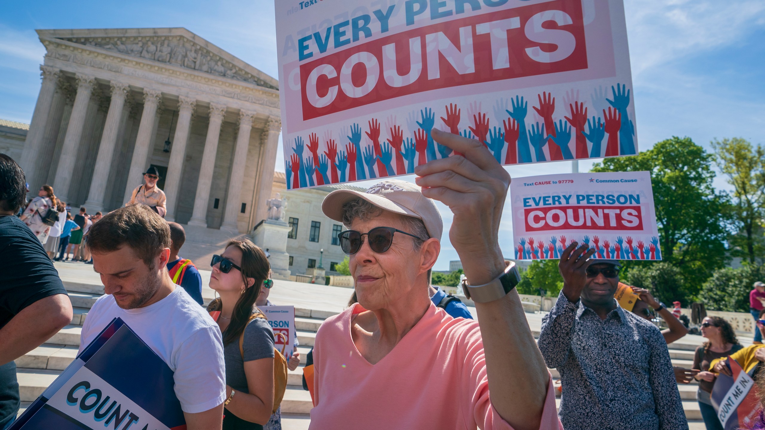 FILE - Immigration activists rally outside the Supreme Court as the justices hear arguments over the Trump administration's plan to ask about citizenship on the 2020 census, in Washington, April 23, 2019. (AP Photo/J. Scott Applewhite, File)