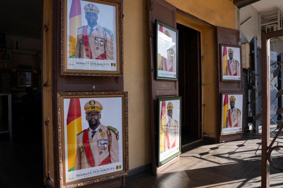 Framed portraits of Guinea's interim president, Col. Mamadi Doumbouya, are displayed side by side in Conakry, Guinea, Wednesday, Sept. 17, 2025. (AP Photo/Misper Apawu)