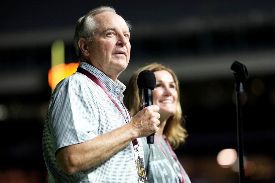 Texas A&M University President Mark A. Welsh, left, addresses the crowd inside Kyle Field as his wife Betty looks on during Midnight Yell in College Station, Texas, Saturday, Aug. 30, 2025. (AP Photo/Sam Craft, File)