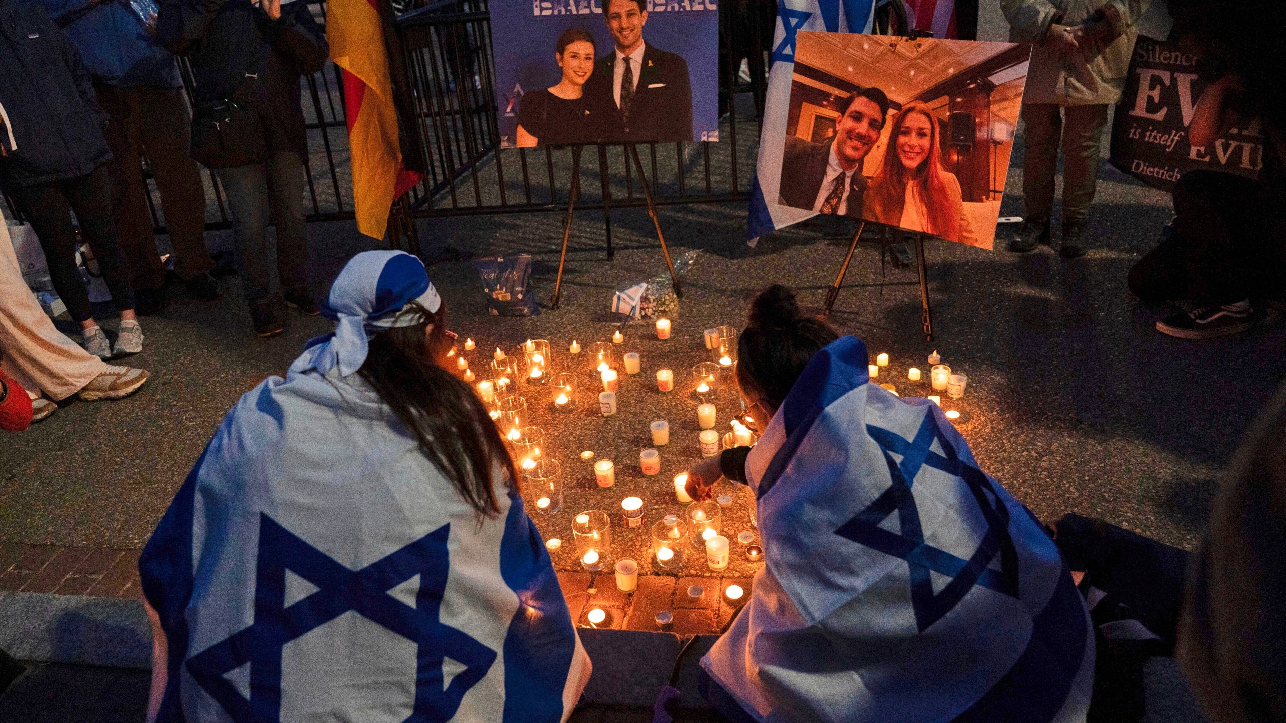 FILE - People gather to light candles in a makeshift memorial to honor Yaron Lischinsky and Sarah Milgrim who were killed as they left an event at the Capital Jewish Museum in Washington, during a candlelight vigil outside of the White House in Washington, Thursday, May 22, 2025. (AP Photo/Jose Luis Magana, File)