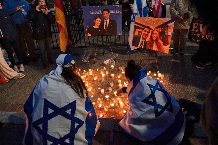 FILE - People gather to light candles in a makeshift memorial to honor Yaron Lischinsky and Sarah Milgrim who were killed as they left an event at the Capital Jewish Museum in Washington, during a candlelight vigil outside of the White House in Washington, Thursday, May 22, 2025. (AP Photo/Jose Luis Magana, File)