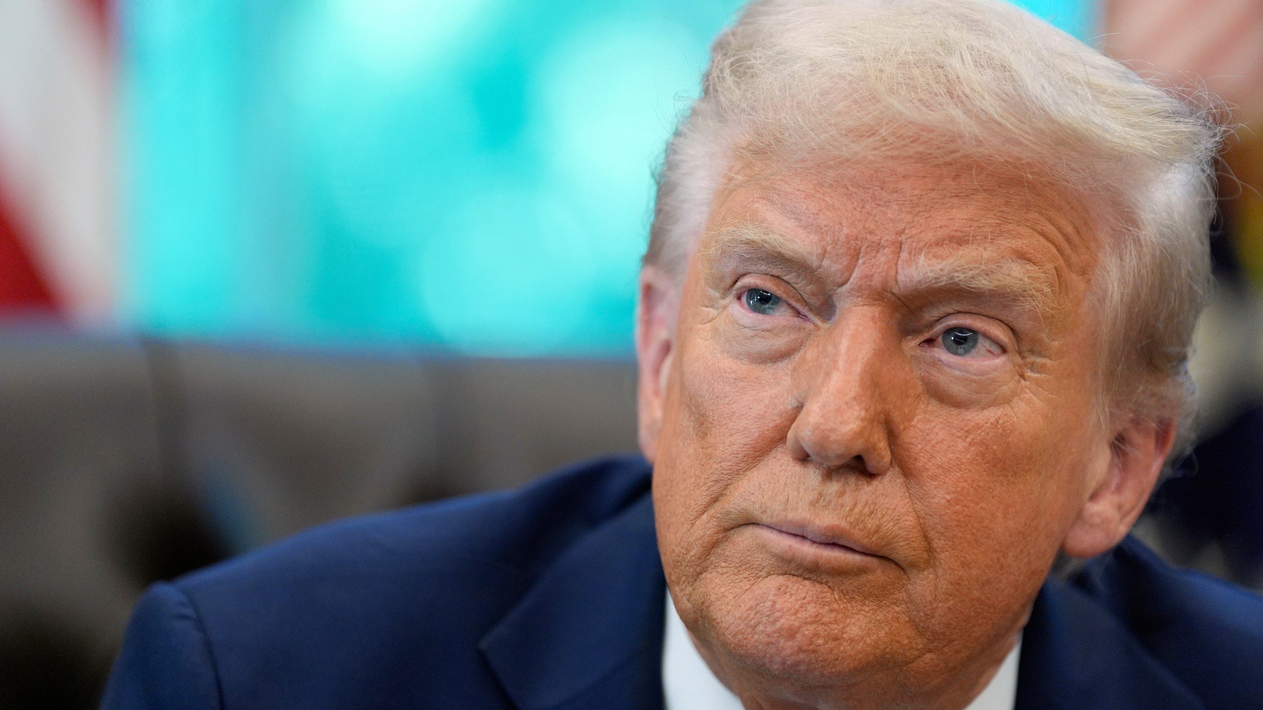 President Donald Trump listens to a reporter's question in the Oval Office of the White House, Friday, Sept. 19, 2025, in Washington. (AP Photo/Alex Brandon)