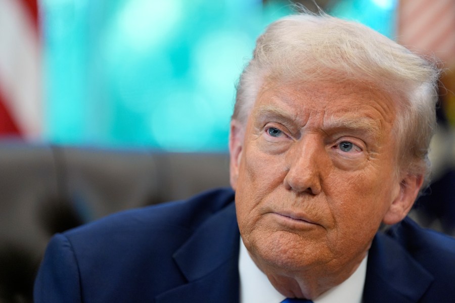President Donald Trump listens to a reporter's question in the Oval Office of the White House, Friday, Sept. 19, 2025, in Washington. (AP Photo/Alex Brandon)
