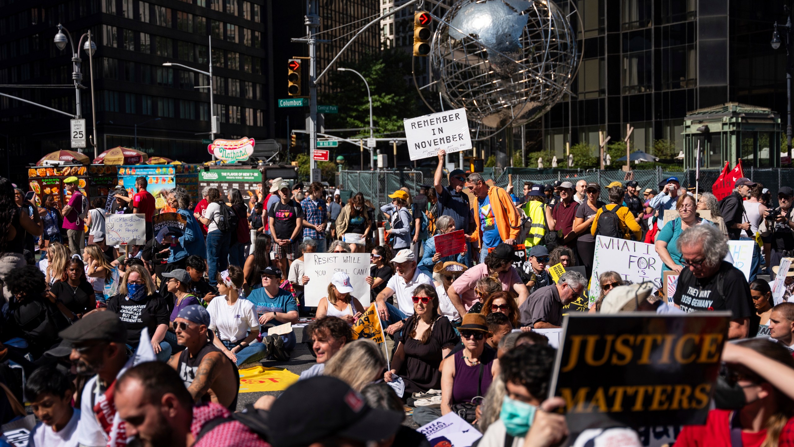 Protestors sit for a moment of silence for the Global South at the "Make Billionaires Pay" climate protest, Saturday, Sept. 20, 2025, in New York. (AP Photo/Angelina Katsanis)