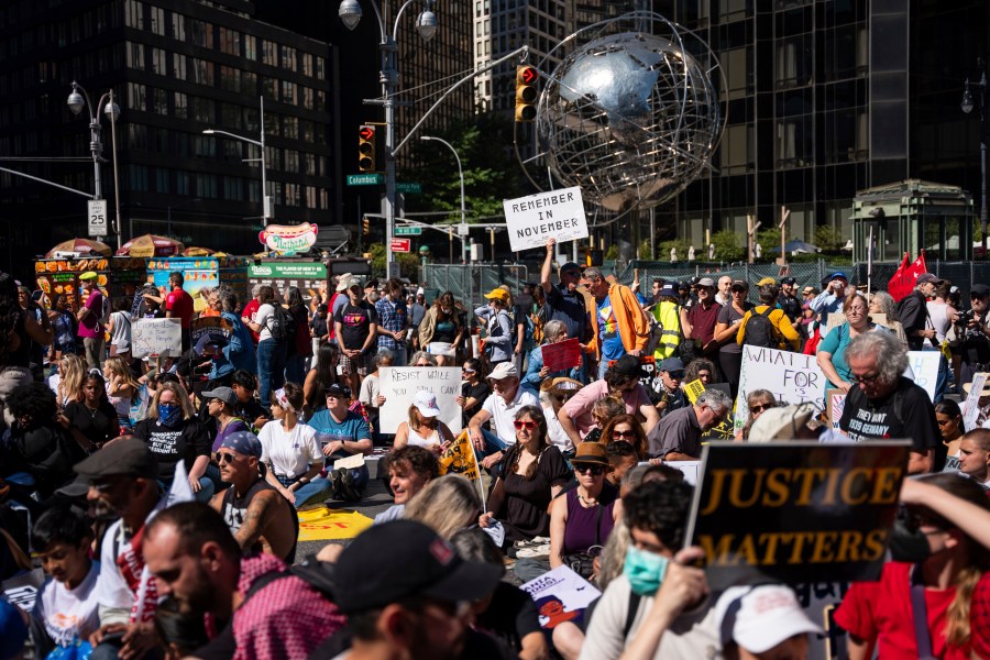 Protestors sit for a moment of silence for the Global South at the "Make Billionaires Pay" climate protest, Saturday, Sept. 20, 2025, in New York. (AP Photo/Angelina Katsanis)