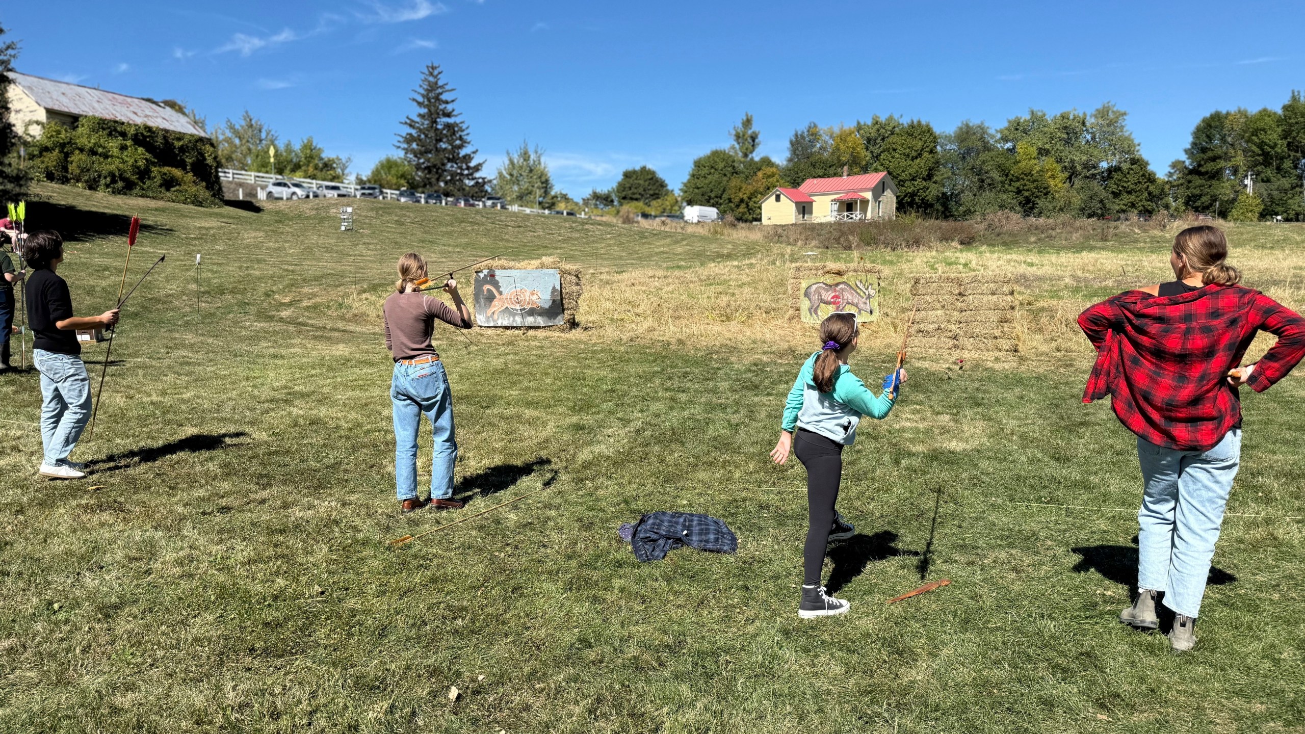 Competitors practice throwing an atlatl at painted animal targets during the Northeastern Atlatl Championship in Addison, Vt. on Saturday, Sept. 20, 2025. (AP Photo/Amanda Swinhart)