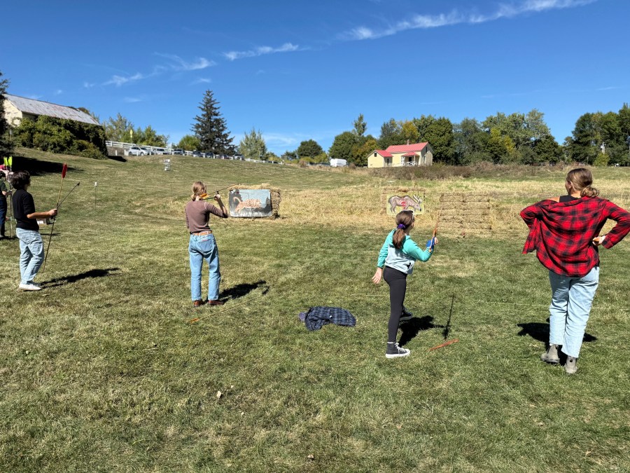 Competitors practice throwing an atlatl at painted animal targets during the Northeastern Atlatl Championship in Addison, Vt. on Saturday, Sept. 20, 2025. (AP Photo/Amanda Swinhart)