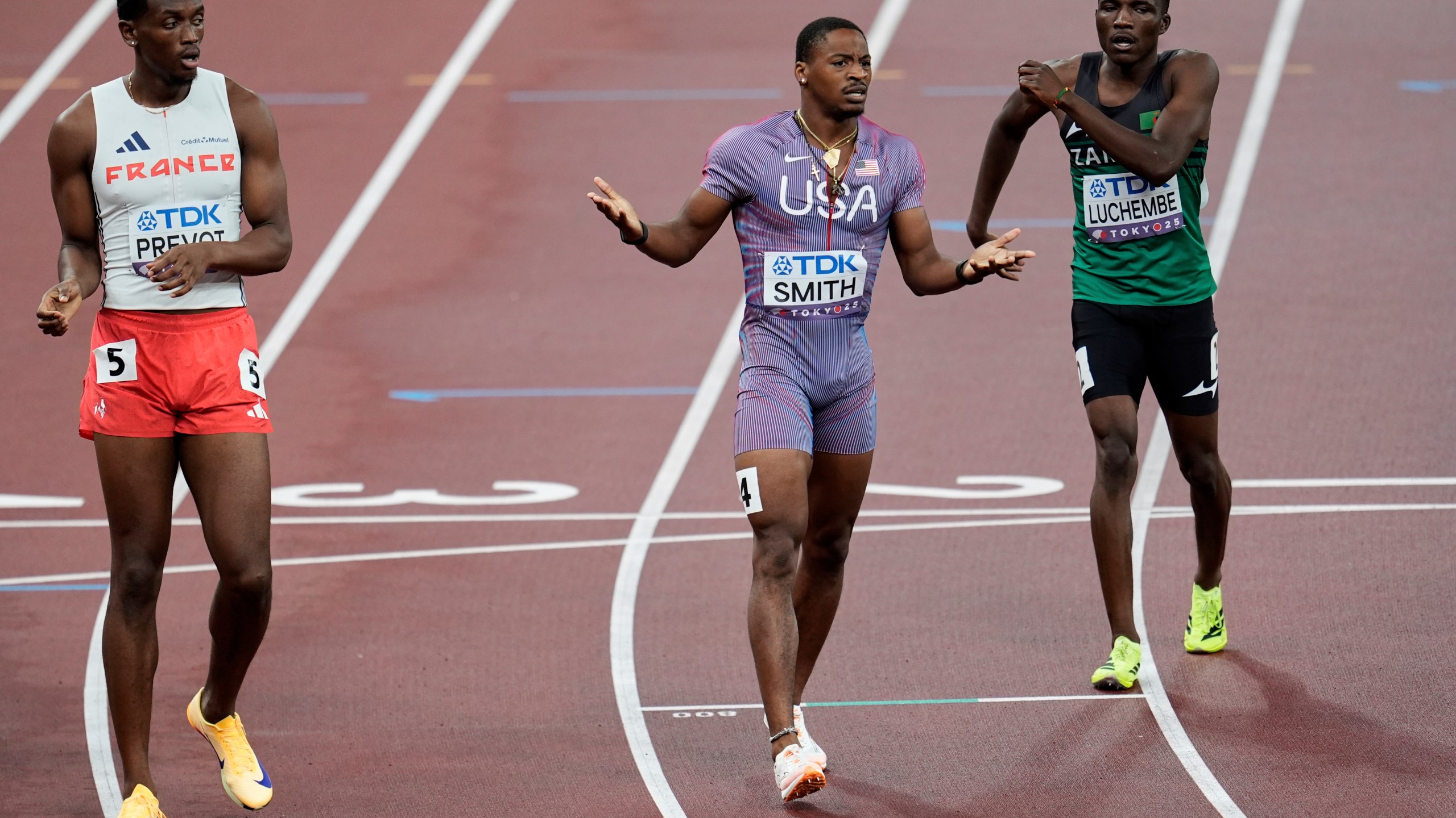 United States' Demarius Smith reacts after a baton change to United States' Bryce Deadmon in a men's 4 X 400 meters relay heat at the World Athletics Championships in Tokyo, Saturday, Sept. 20, 2025. (AP Photo/Abbie Parr)