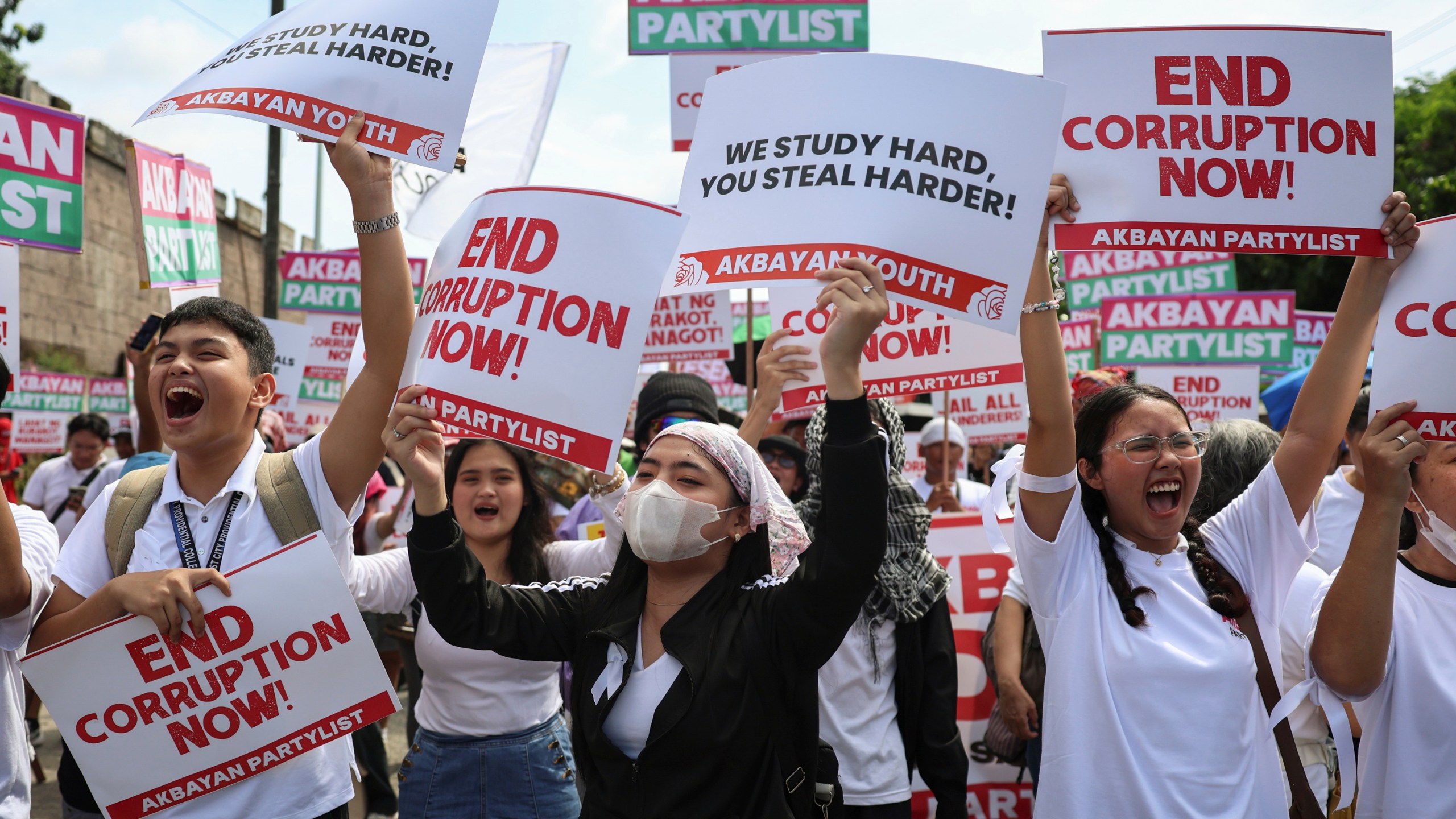 Protesters carry signs as they gather during a rally against government corruption at the EDSA People Power Monument in suburban Mandaluyong, east of Manila, Philippines, Sunday. Sept. 21, 2025. (AP Photo/Basilio Sepe)